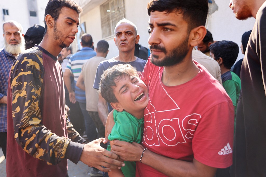 A Palestinian boy mourns a relative, killed in an Israeli strike, outside the al-Shifa hospital in Gaza City on July 7, 2025.