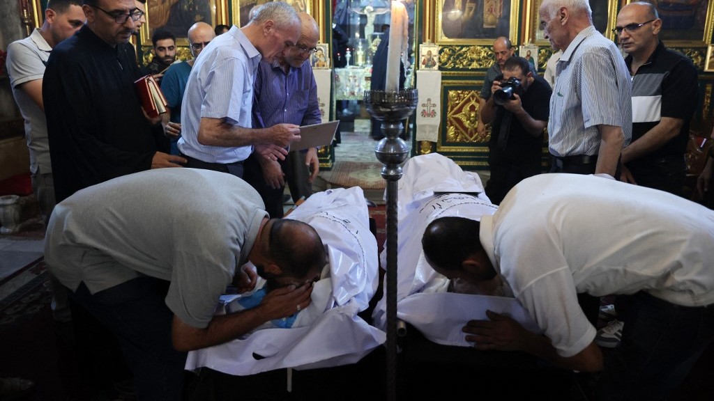 Christian Palestinian mourners bid farewell to Saad Salameh and Foumia Ayyad, killed in an Israeli strike that hit the Holy Family church in Gaza City, during their funeral ceremony at the Saint Porphyrius Church on July 17, 2025. (Omar Al Qattaa/AFP)