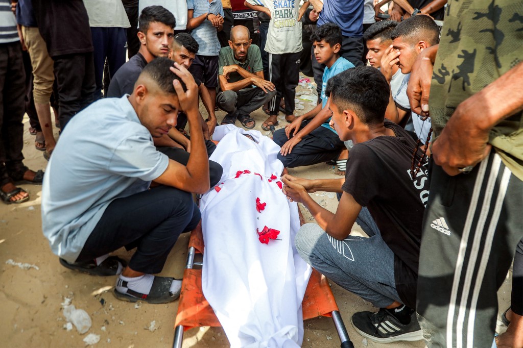 Mourners bid farewell to the body of one of the victims killed during overnight Israeli bombardment on a camp sheltering displaced people in the Mawasi area of Khan Yunis, during the funeral at Nasser Medical Complex in Khan Yunis in the southern Gaza Strip on August 5, 2025