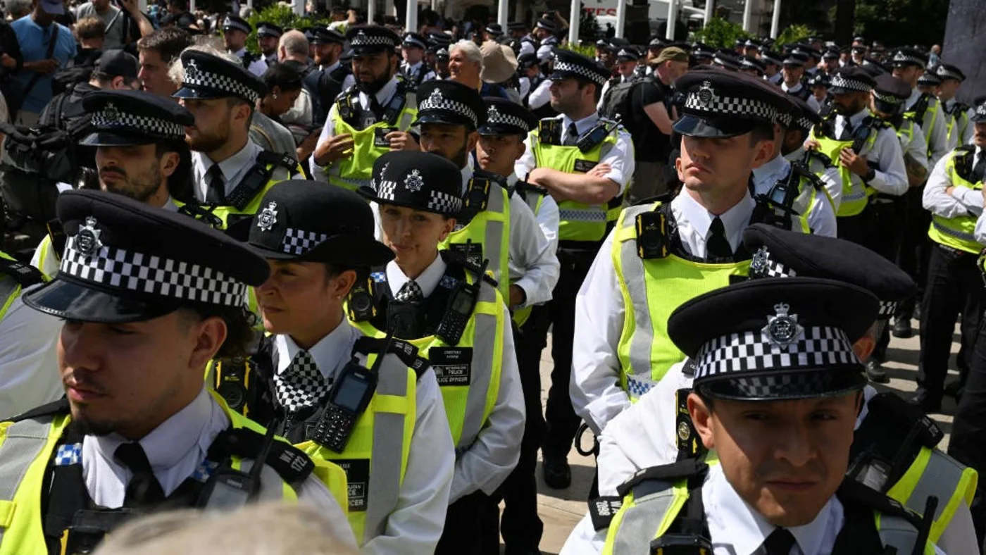 Members of the Metropolitan Police gather in Parliament Square ahead of a 