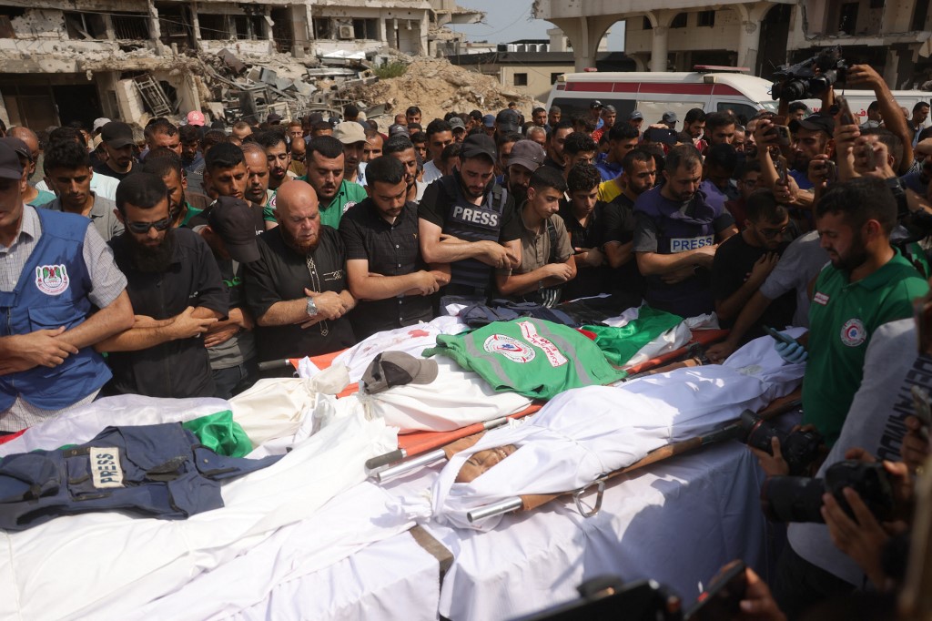 Mourners pray during a group funeral for Palestinians, including journalists and a medic, killed in an overnight Israeli strike, outside the Al-Shifa Hospital in Gaza City on August 11, 2025.