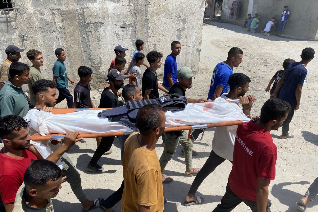 Mourners carry the body of one of five journalists killed in an Israeli strike on Nasser hospital in Khan Yunis in the southern Gaza Strip, during their funeral on August 25, 2025.