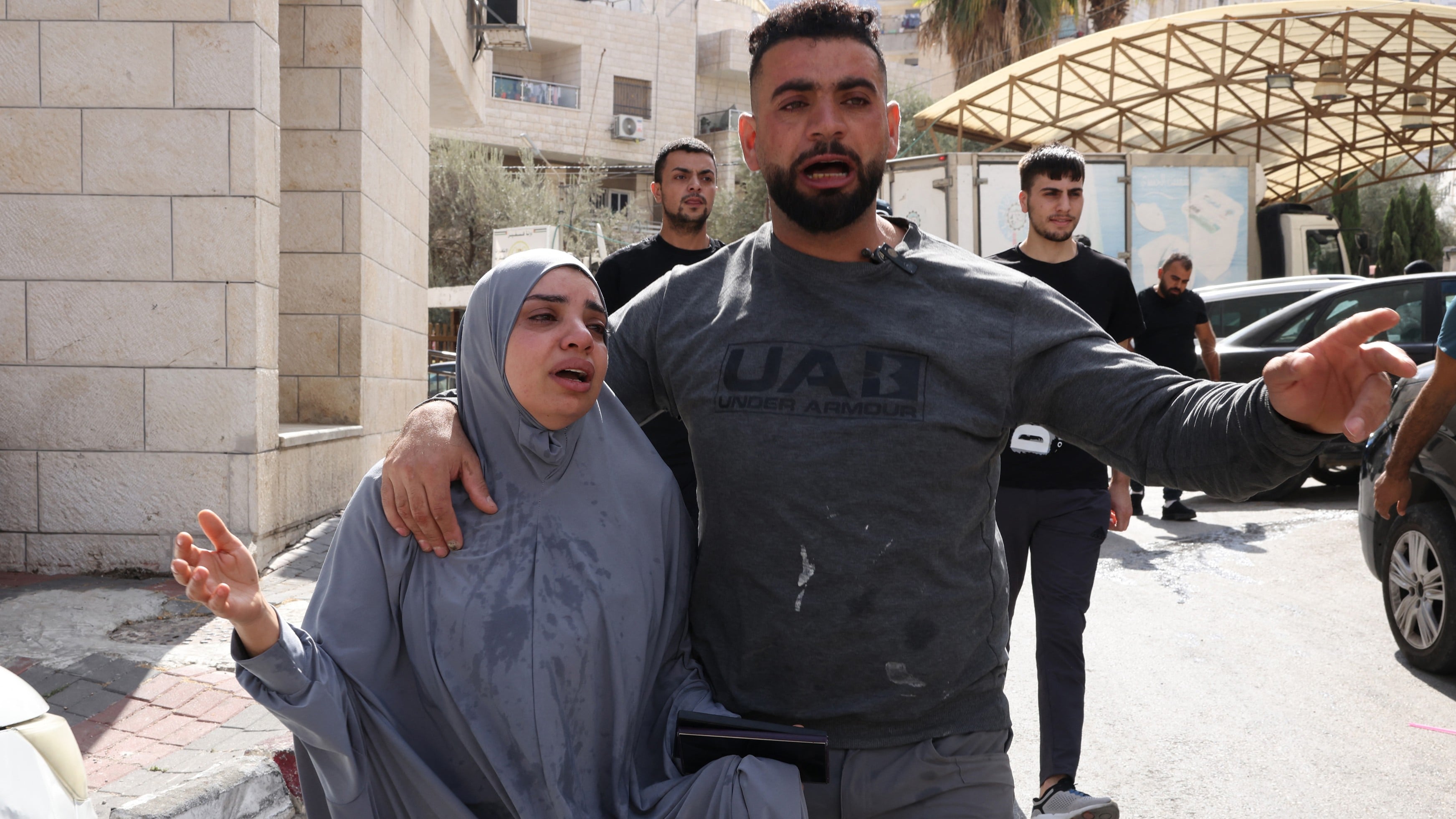 Wife of Majed Mohammed Daoud, a 42-year-old Palestinian killed by Israeli forces, is comforted by a relative in the occupied West Bank city of Nablus on 19 October 2025 (AFP/Hazem Bader)