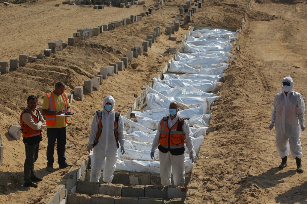Health and civilian workers prepare for a mass burial of Palestinians at a cemetery in Khan Yunis, in the southern Gaza Strip, on November 10, 2025. 