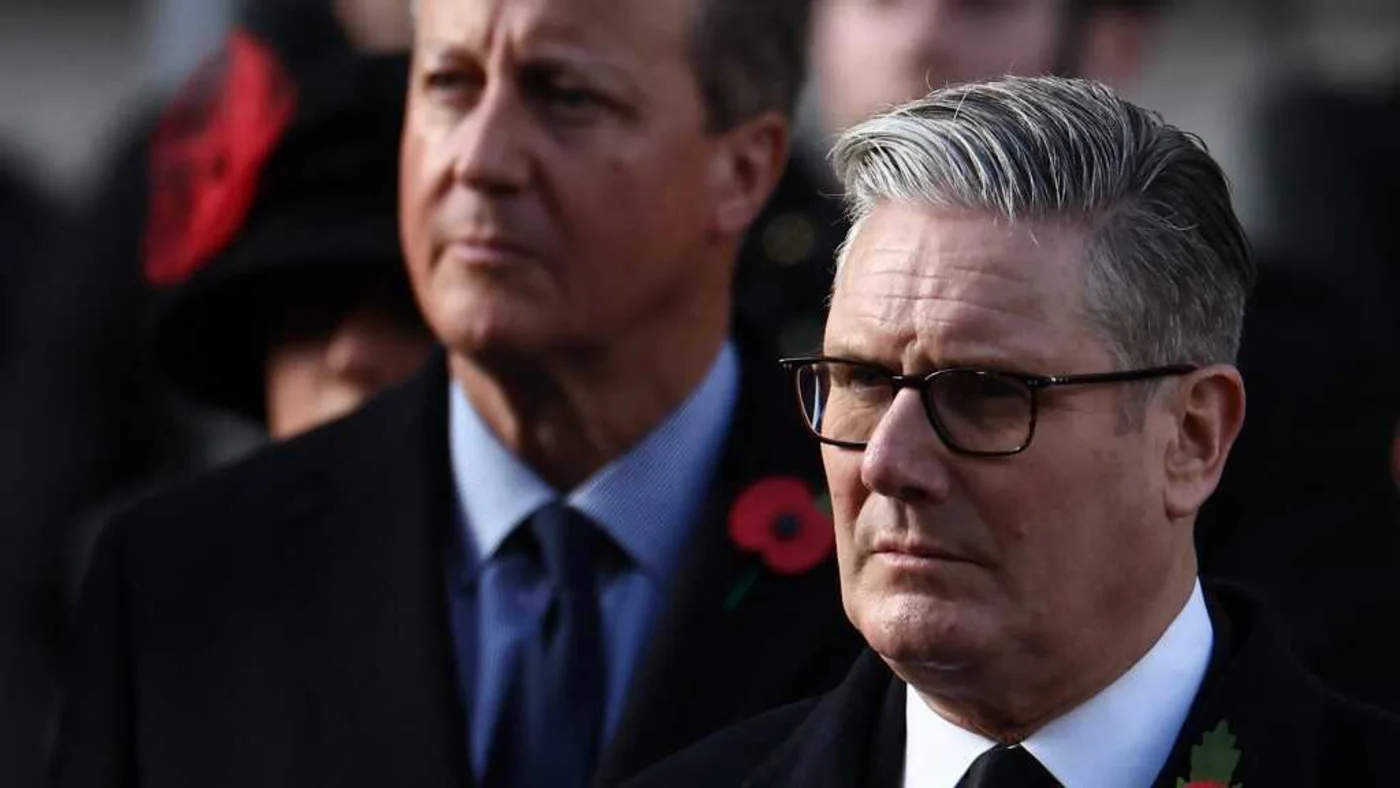 Britain's Prime Minister Keir Starmer (R) and former Prime Minister David Cameron (L) attend the Remembrance Sunday ceremony at the Cenotaph in London on 9 November 2025 (AFP)