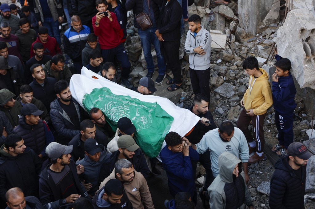Mourners attend the funeral of those killed in an Israeli airstrike at al-Shati camp for Palestinian refugees, west of Gaza City on December 14, 2025. 
