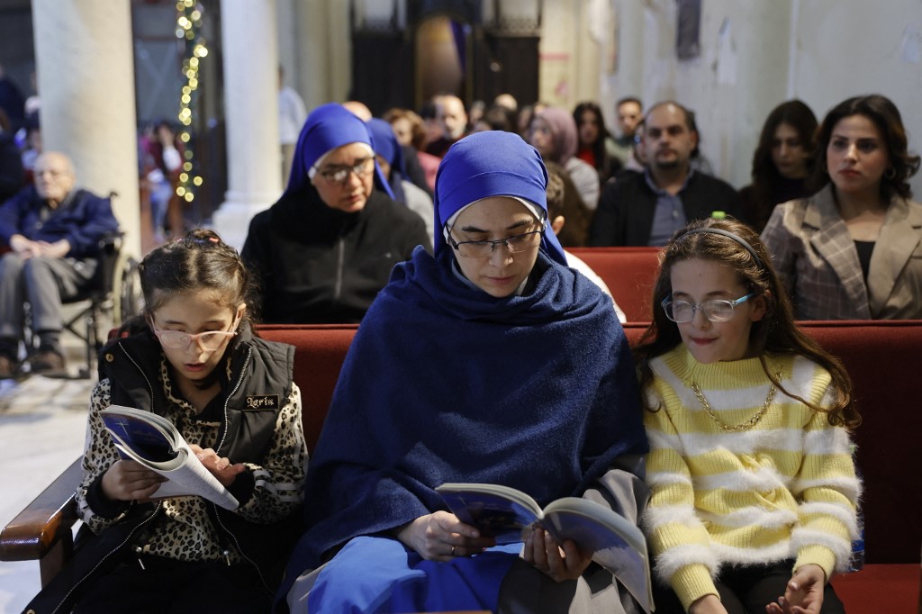 Nuns and displaced worshippers attend a Christmas mass at the Roman Catholic Church of the Holy Family in Gaza City on 24 December, 2025. (AFP)