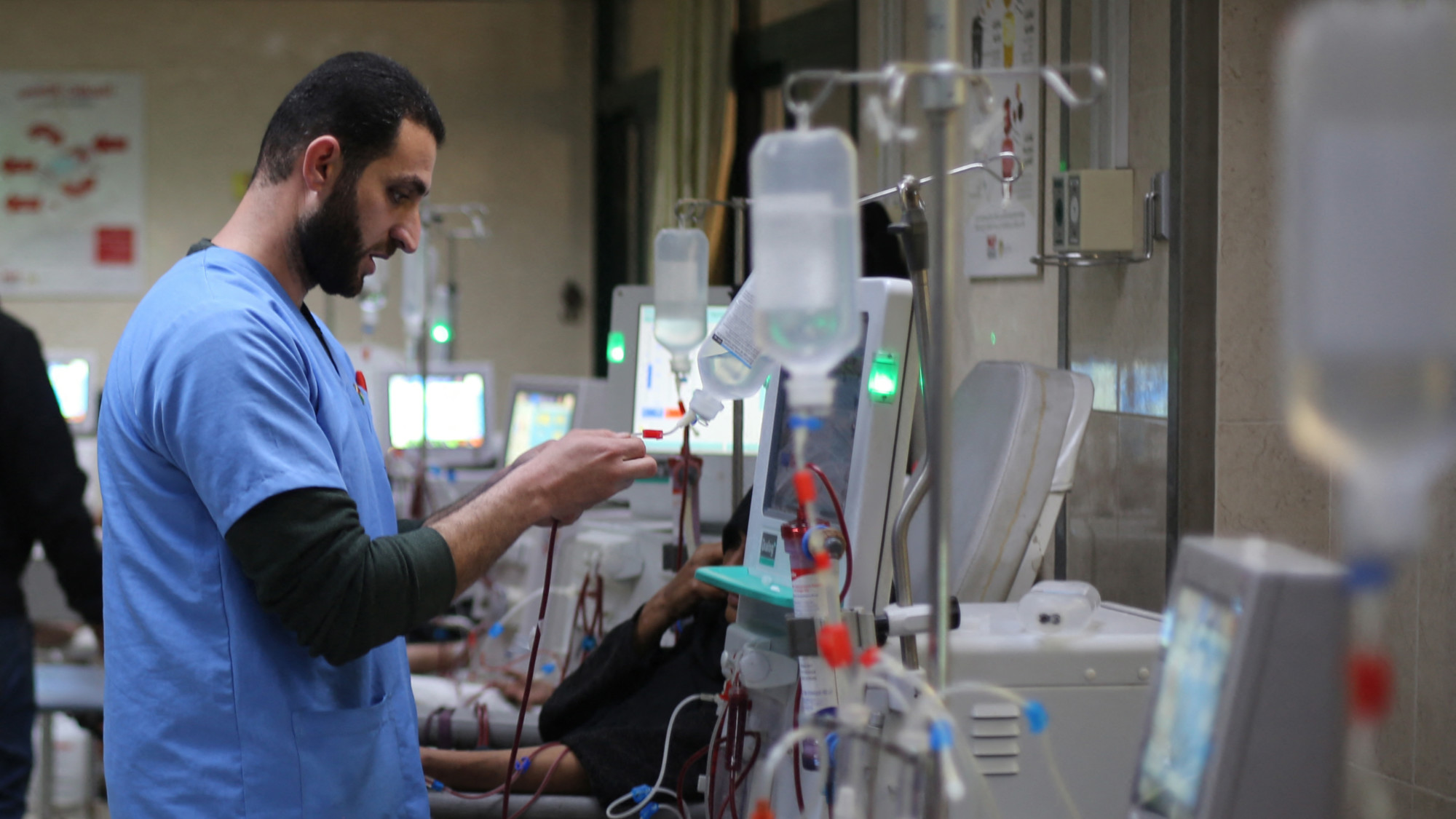 A Palestinian doctor checks a drip at the dialysis treatment centre at Al-Aqsa Martyrs Hospital, in Deir al-Balah in the central Gaza Strip, on 1 February 2026 (Eyad Baba/AFP)