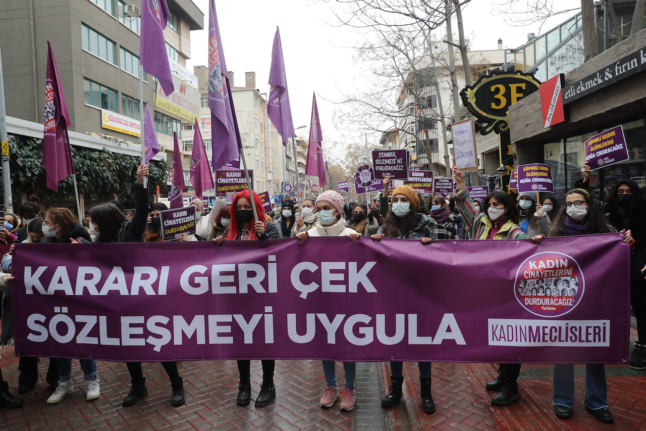 Protesters hold a banner reading 'Withdraw the decree and respect the Istanbul Convention' during a demonstration against Turkey's withdrawal from Istanbul Convention in Ankara (AFP)