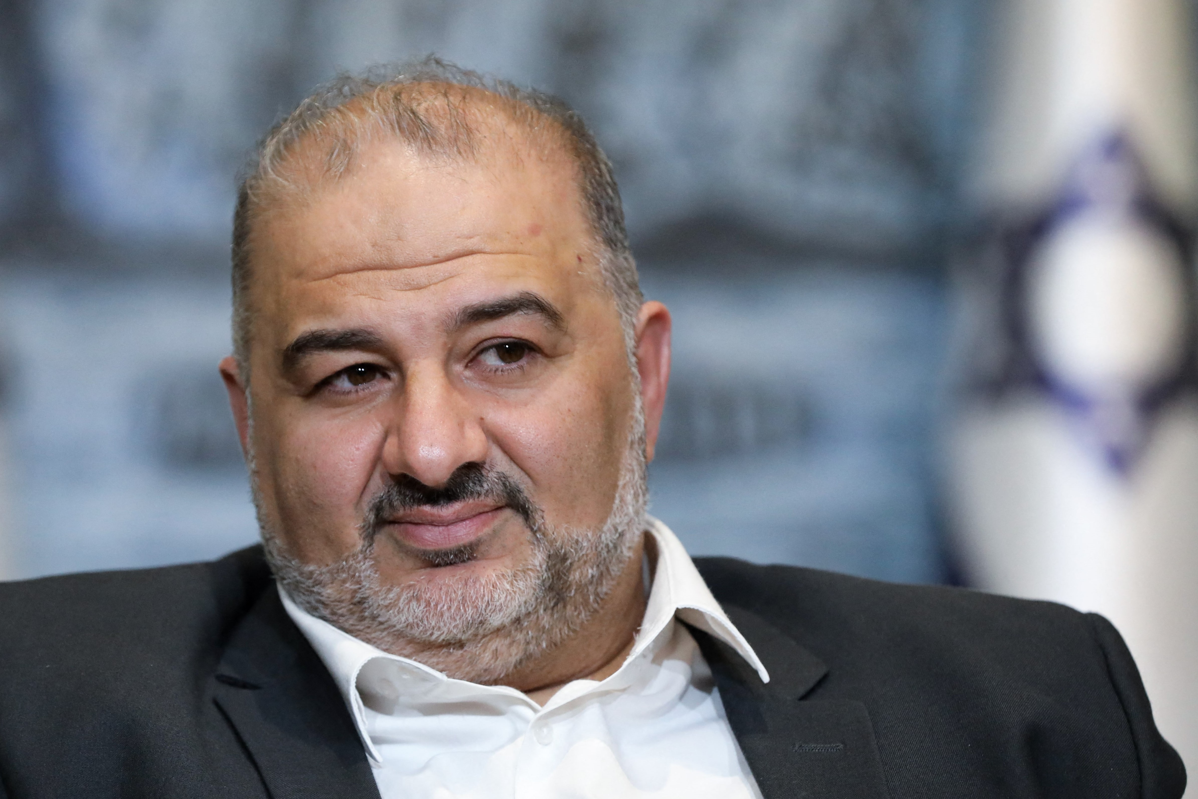 Mansour Abbas, leader of an Islamist party for Palestinians in Israel, signing an agreement on Wednesday night to sit in a 