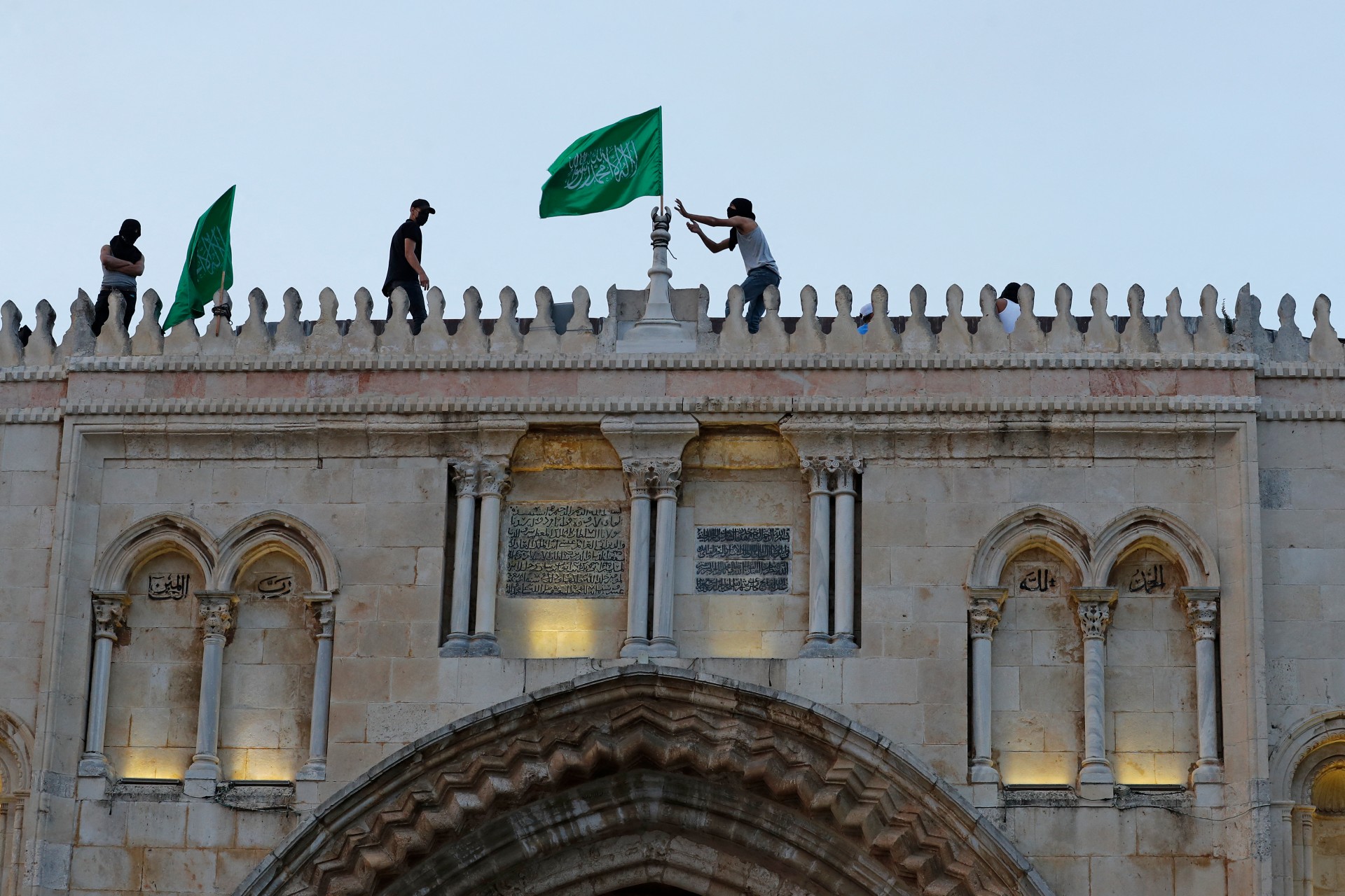Palestinians place the Hamas movement flags atop al-Aqsa mosque (AFP)