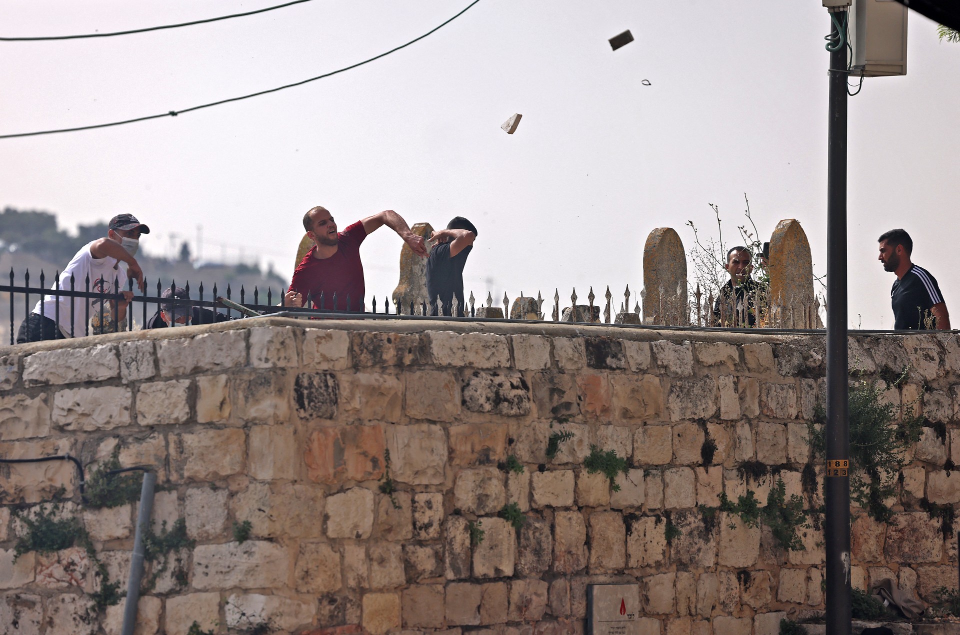 Palestinians hurl stones at Israeli forces during a raid on al-Aqsa Mosque (AFP)