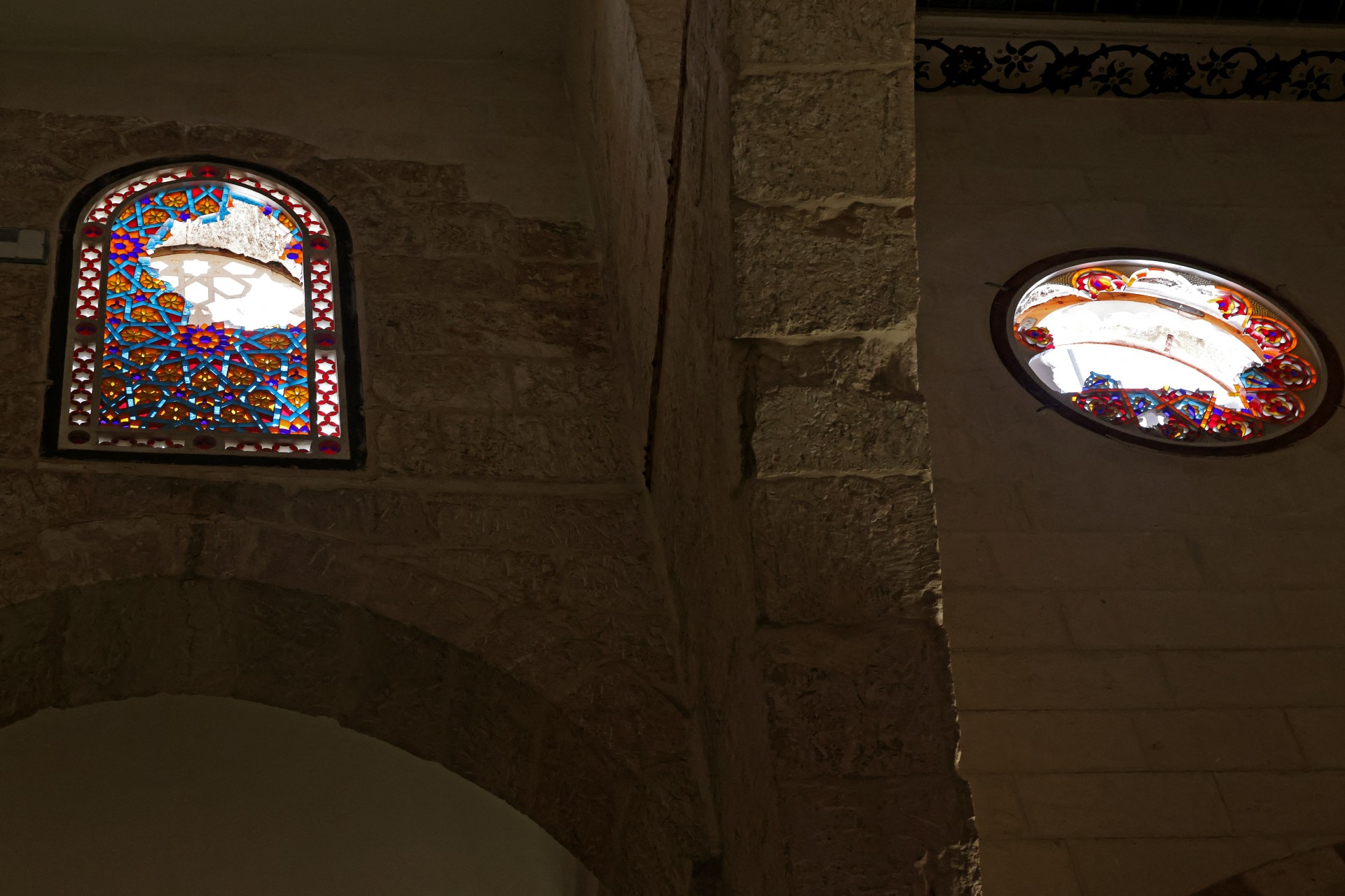 The windows of al-Aqsa Mosque are seen shattered following a violent Israeli raid (AFP)
