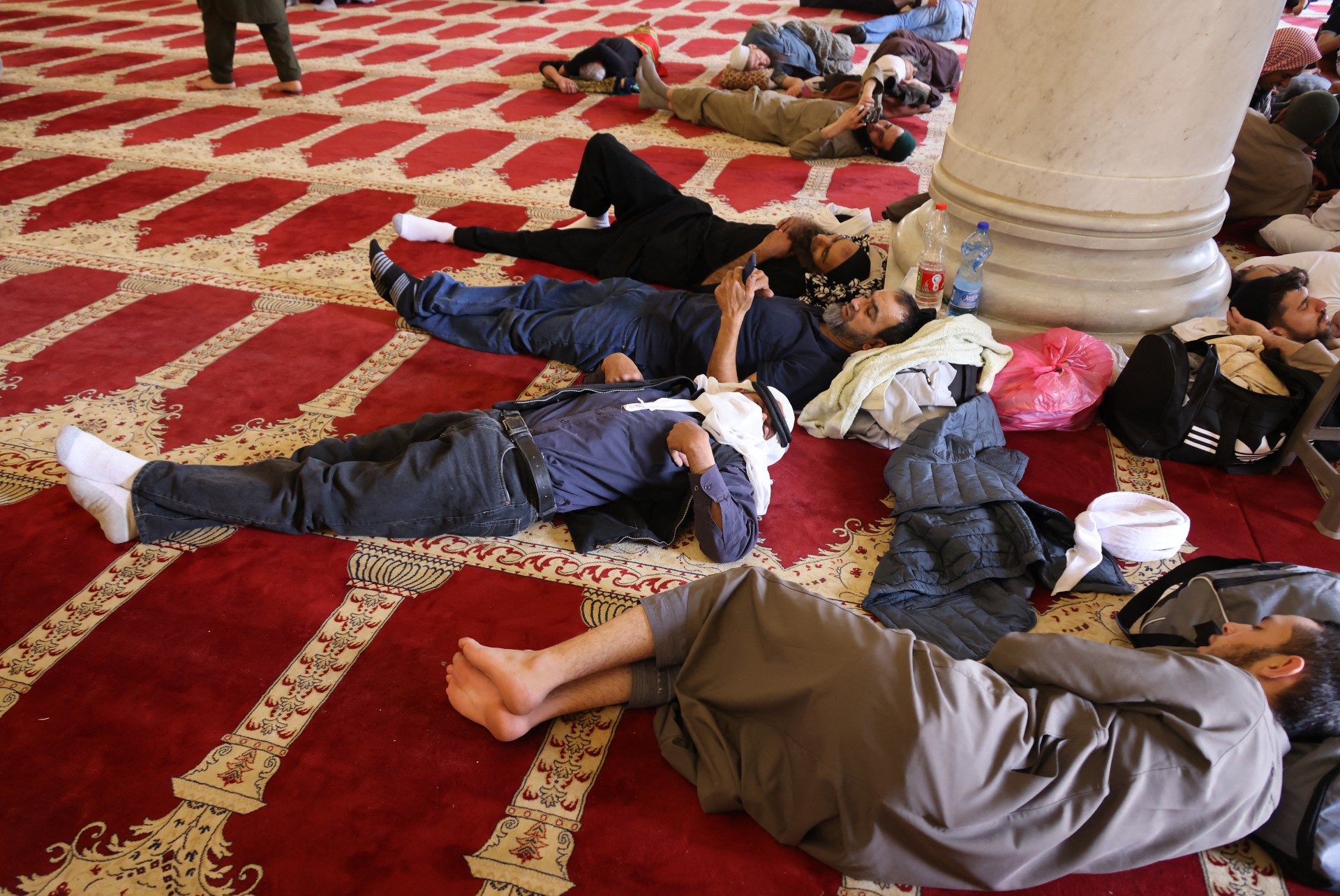 Palestinian worshippers rest at Jerusalem's al-Aqsa Mosque during the last days of Muslim holy month of Ramadan (AFP)