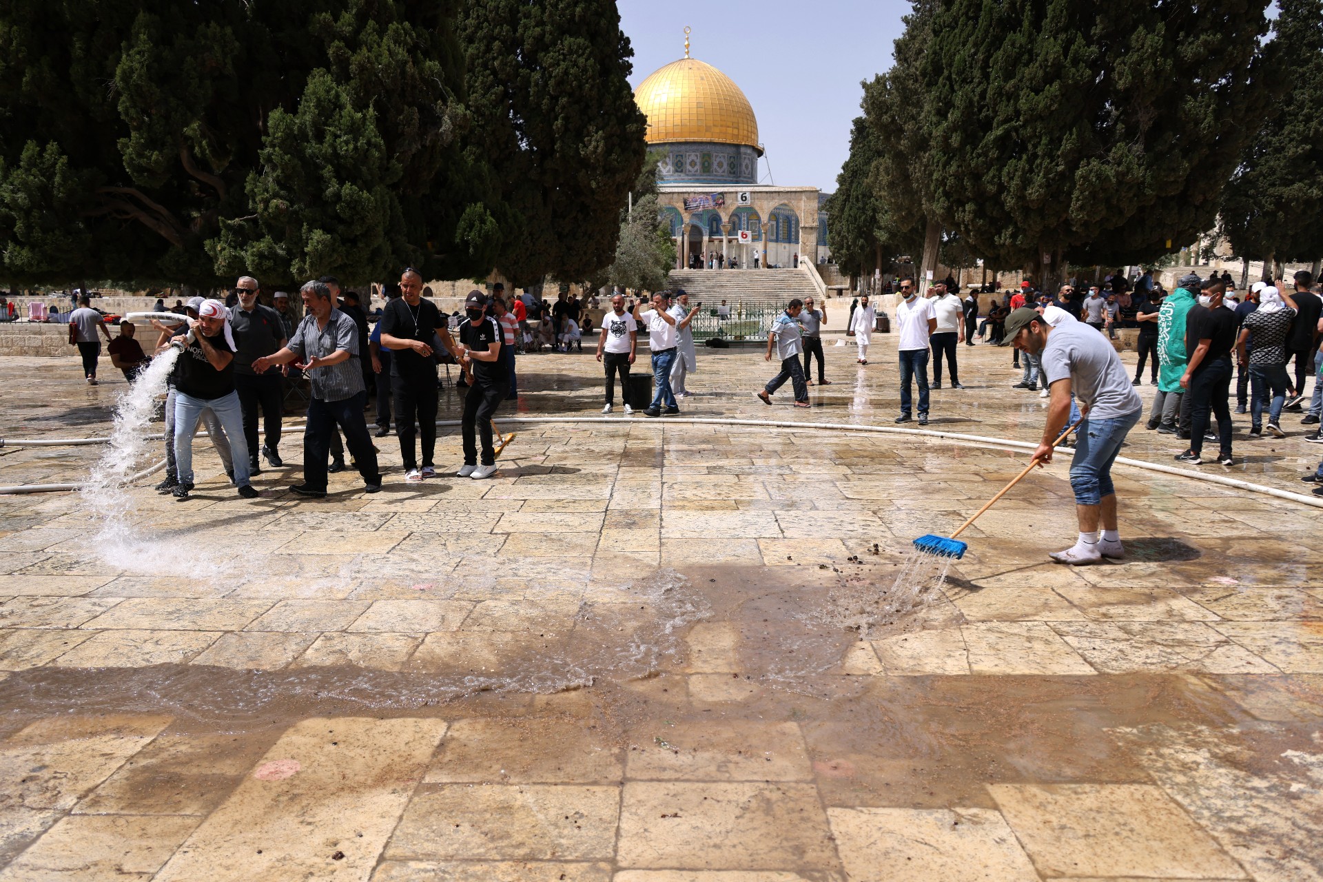 Palestinians clean at Jerusalem's al-Aqsa Mosque courtyard (AFP)