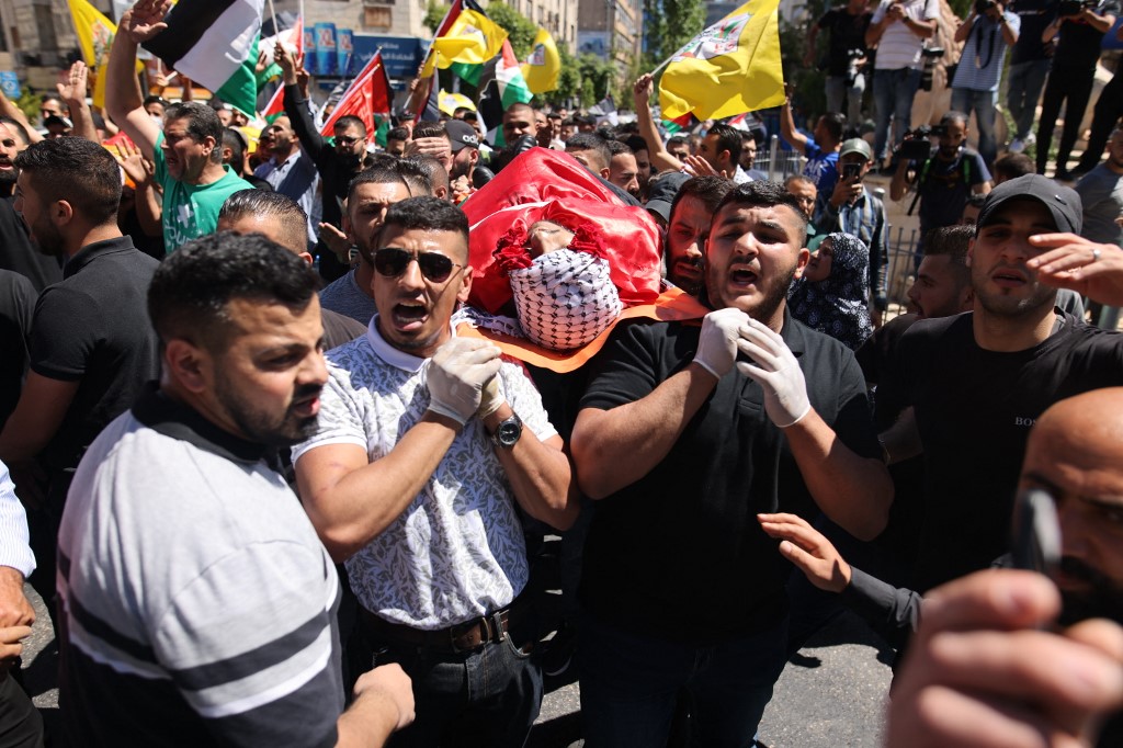 Relatives carry the body of 20-year-old Adham al-Kashef during his funeral in the city of al-Bireh, northeast of Ramallah  (AFP)