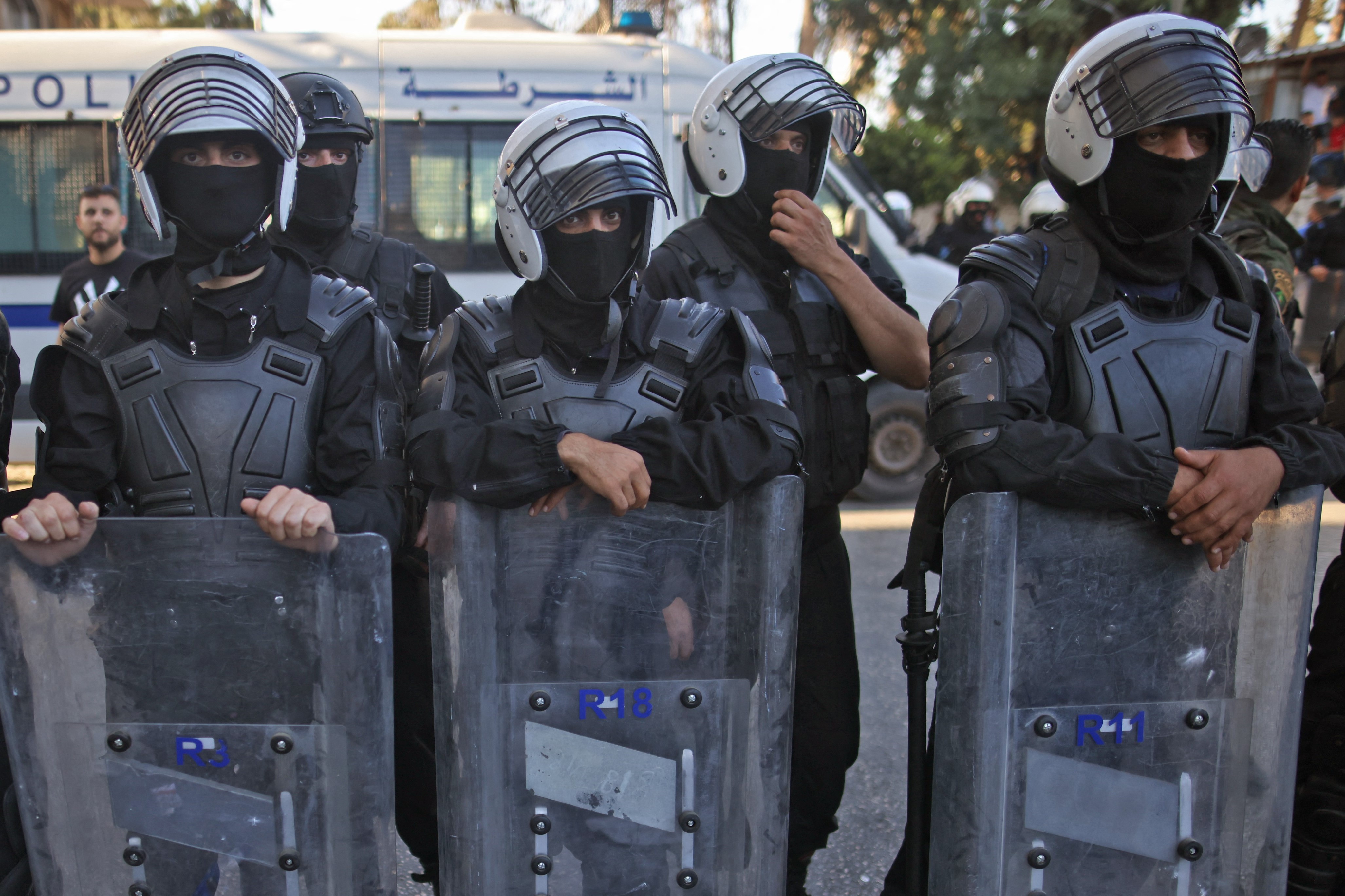 Palestinian security forces block a road during a demonstration in the city of Ramallah in the occupied West Bank, on June 26, 2021