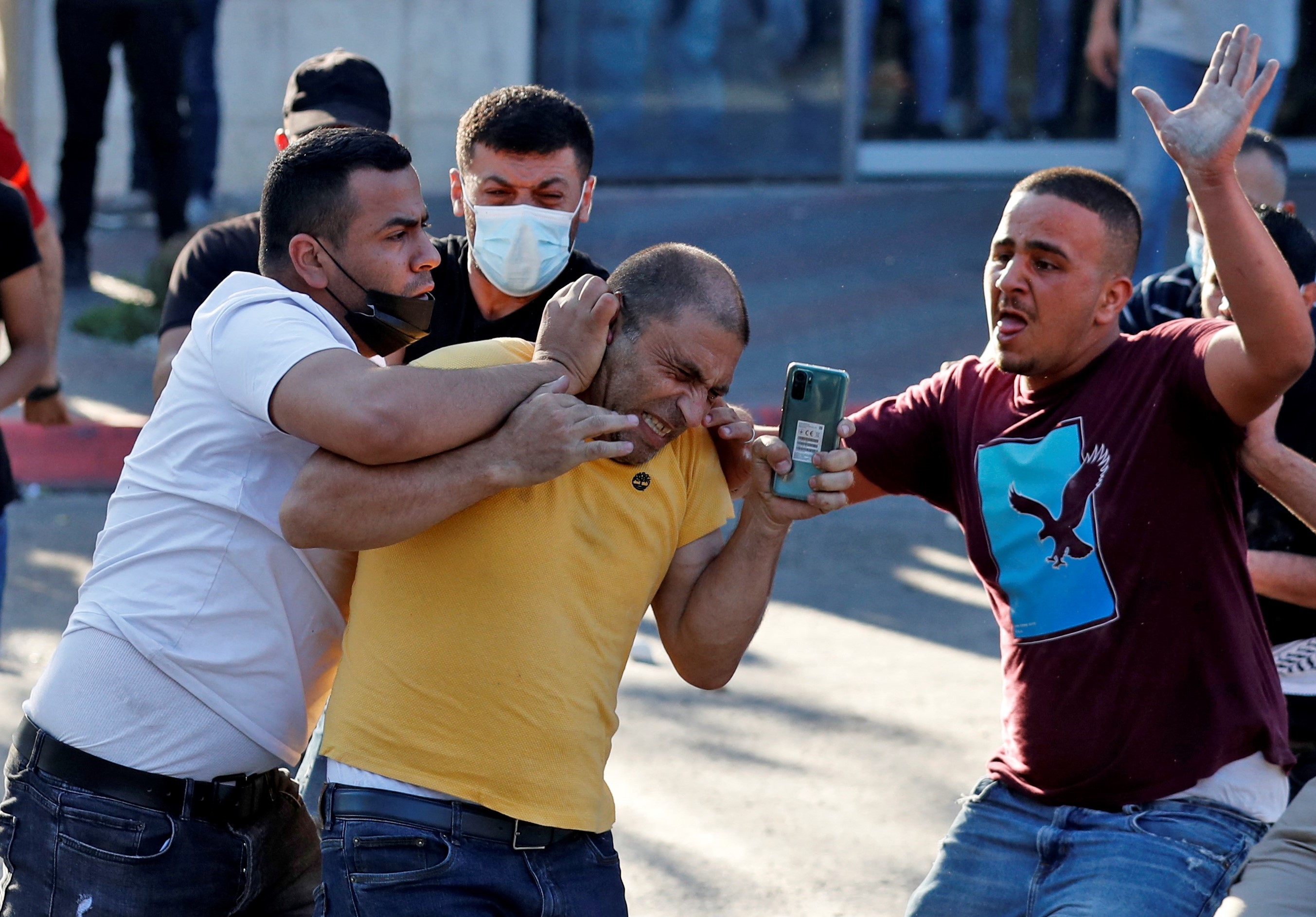 Palestinian plain-clothed security officers detain a man during a demonstration in the city of Ramallah in the occupied West Bank, on June 26, 2021, to protest the death of human rights activist Nizar Banat