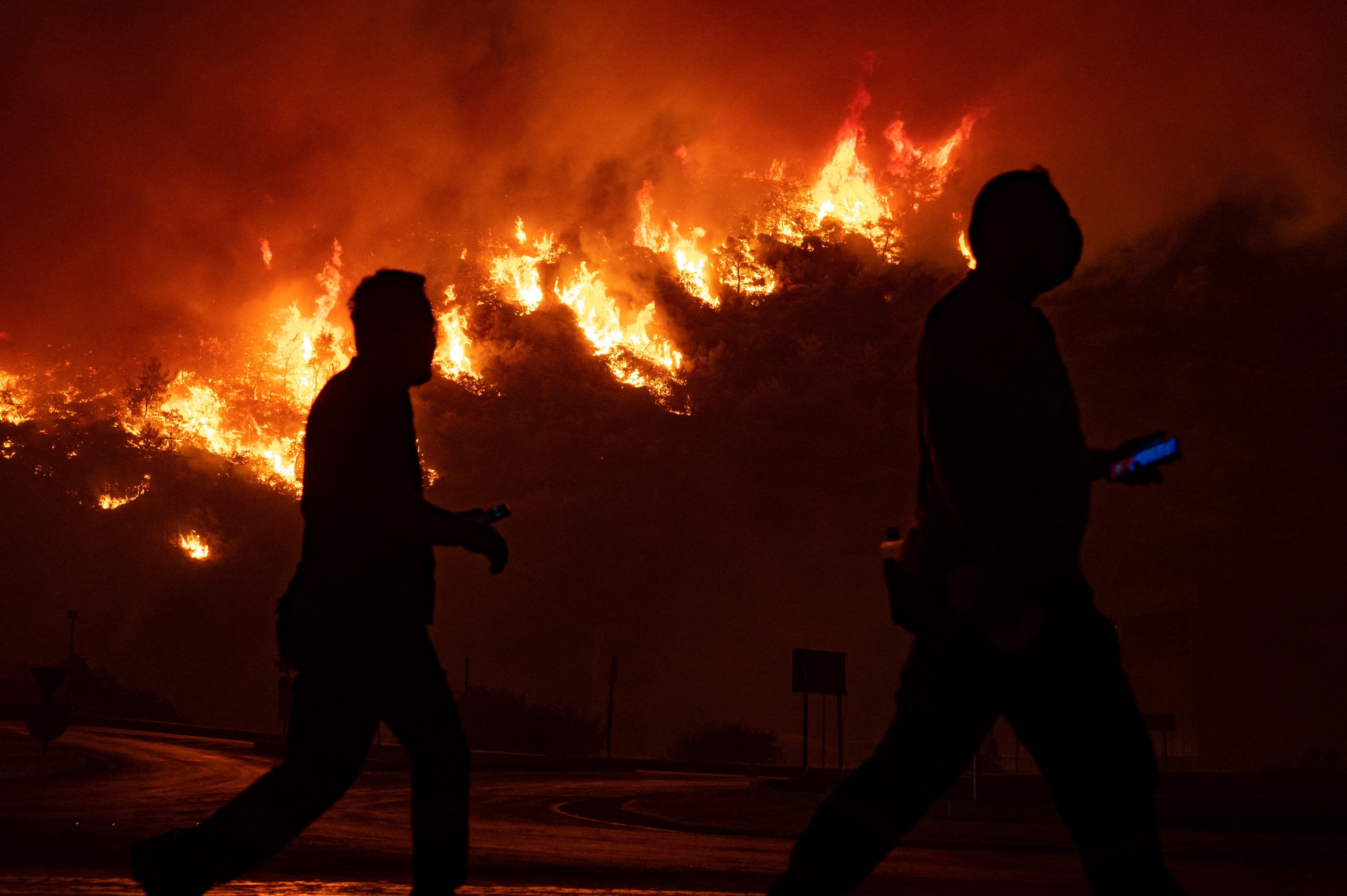 Raging fires burn close to the Kemerkoy Thermal Power Plant, at Oren near the town of Milas on August 4, 2021. The thermal power plant on the Aegean Sea was being evacuated on August 4, 2021