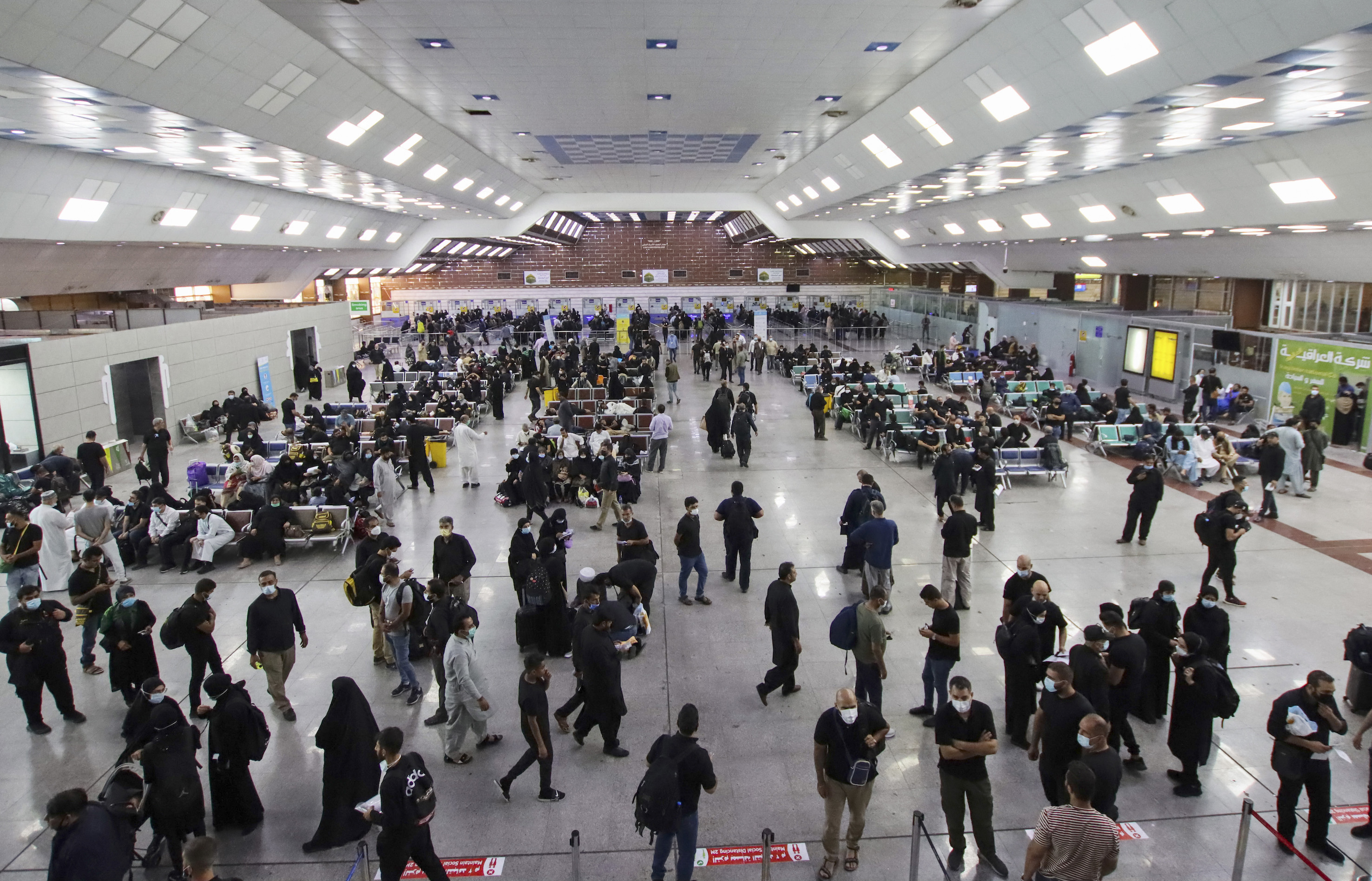 Shia Muslim pilgrims arrive at the Najaf airport in Iraq, on 23 September 23, 2021, ahead of the yearly march to the city of Karbala (AFP/ Ali Najafi)