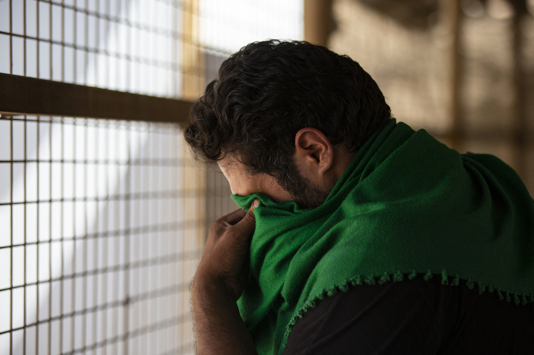 An Iranian pilgrim reacts upon his arrival to Iraq to mark Arbaeen (AFP/ Hussein Faleh)