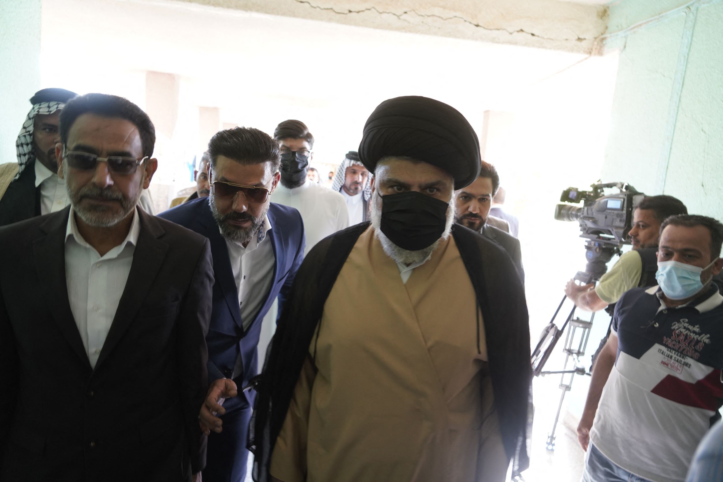 Iraqi cleric Moqtada Sadr leaves a polling station after casting his vote, in the central Iraqi shrine city of Najaf (AFP)