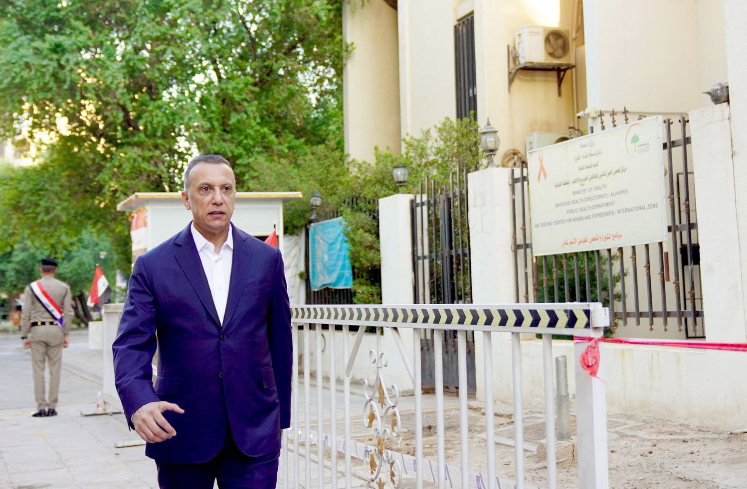 A handout picture released by Iraq's Prime Minister's Media Office shows Iraqi Prime Minister Mustafa Al-Kadhemi arriving at a polling station to cast his vote in the capital Baghdad