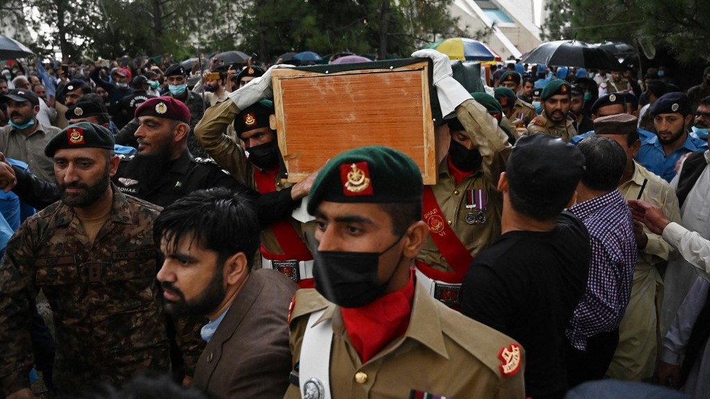Soldiers carry the flag-drapped coffin of AQ Khan during his funeral outside the Faisal Mosque following his death in Islamabad on October 10, 2021 (AFP)