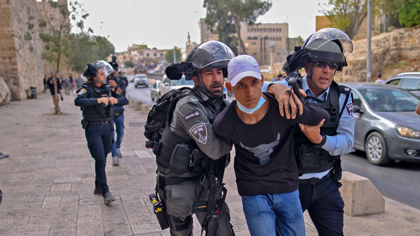 sraeli security forces detain a Palestinian man during a protest in the al-Yusufiye cemetery near the Lion's Gate entrance to the Al-Aqsa mosque compound in east Jerusalem, on October 29, 2021,