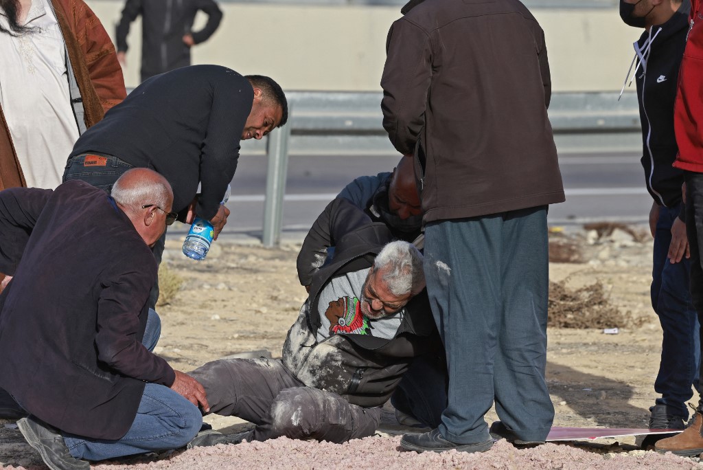 An injured protester is helped by other Palestinian Bedouins as Israeli forces cracked down on a protests against an afforestation project (Afp)