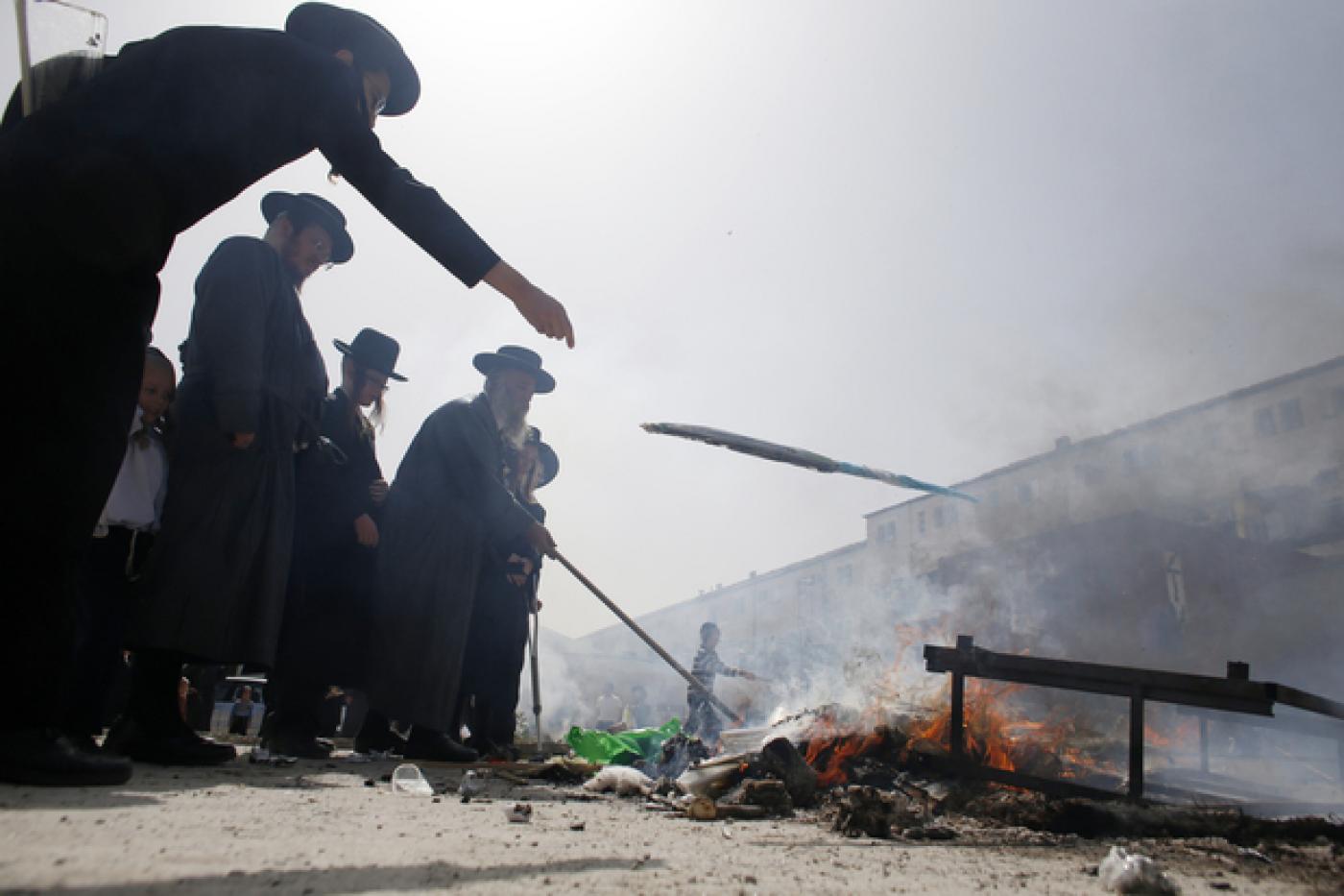 Des juifs ultra-orthodoxes brûlent des produits au levain à Jérusalem au cours des derniers préparatifs de la fête de la Pâque juive (AFP)