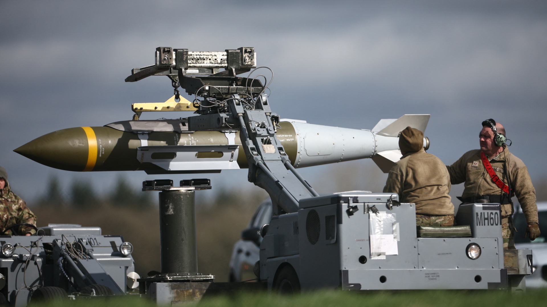Joint Direct Attack Munitions (JDAMs) are taken away having been removed from a US Air Force B-1 Lancer bomber at RAF Fairford in south-west England on 15 March 2026 (Henry Nicholls/AFP)