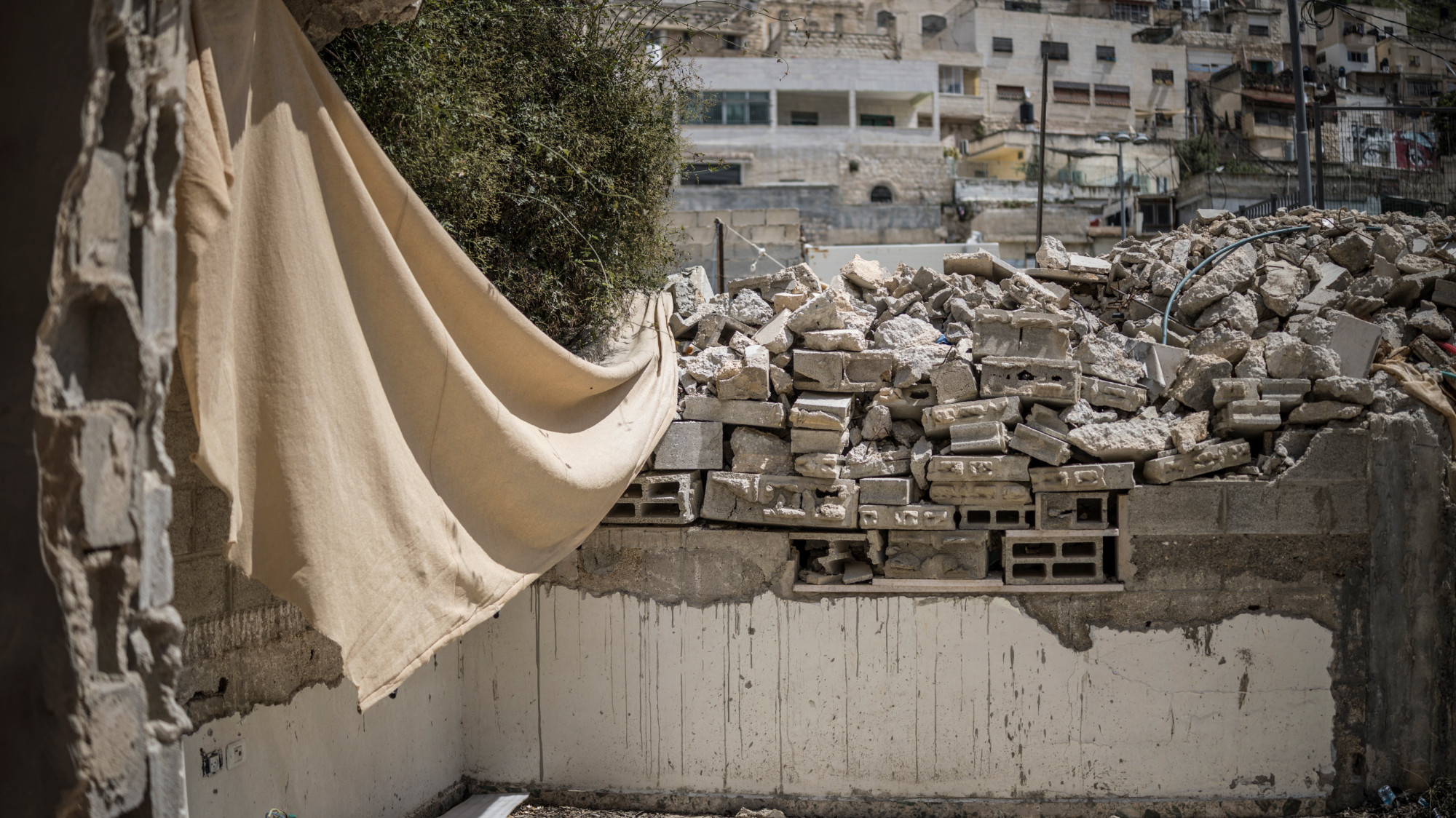A demolished section of the family home of Fakhri Abu Diab is pictured in the yard of the home in Silwan in occupied East Jerusalem, on 12 April 2026 (AFP/Marco Longari)