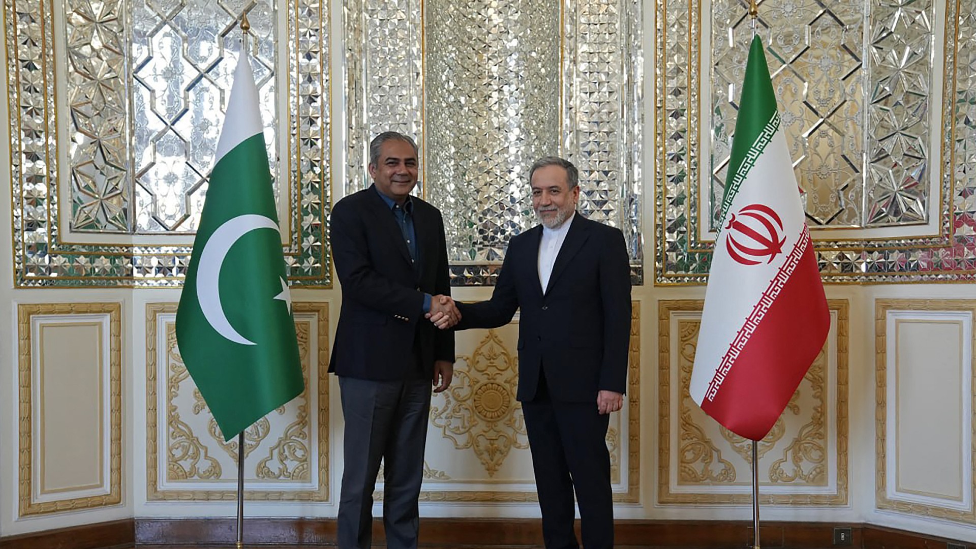 This handout photograph taken and released by the Iranian Foreign Ministry on June 7, 2026 shows Iran's Foreign Minister Abbas Araghchi (R) shaking hands with Pakistan's Interior Minister Mohsin Naqvi before their meeting in Tehran. Iranian Foreign Ministry / AFP