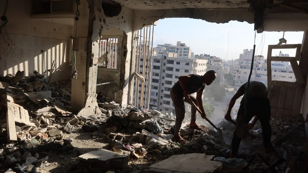 Palestinian residential salvage what they can from an apartment targeted in overnight Israeli airstrikes in Gaza City on August 2, 2026. (Omar Al Qattaa/AFP)