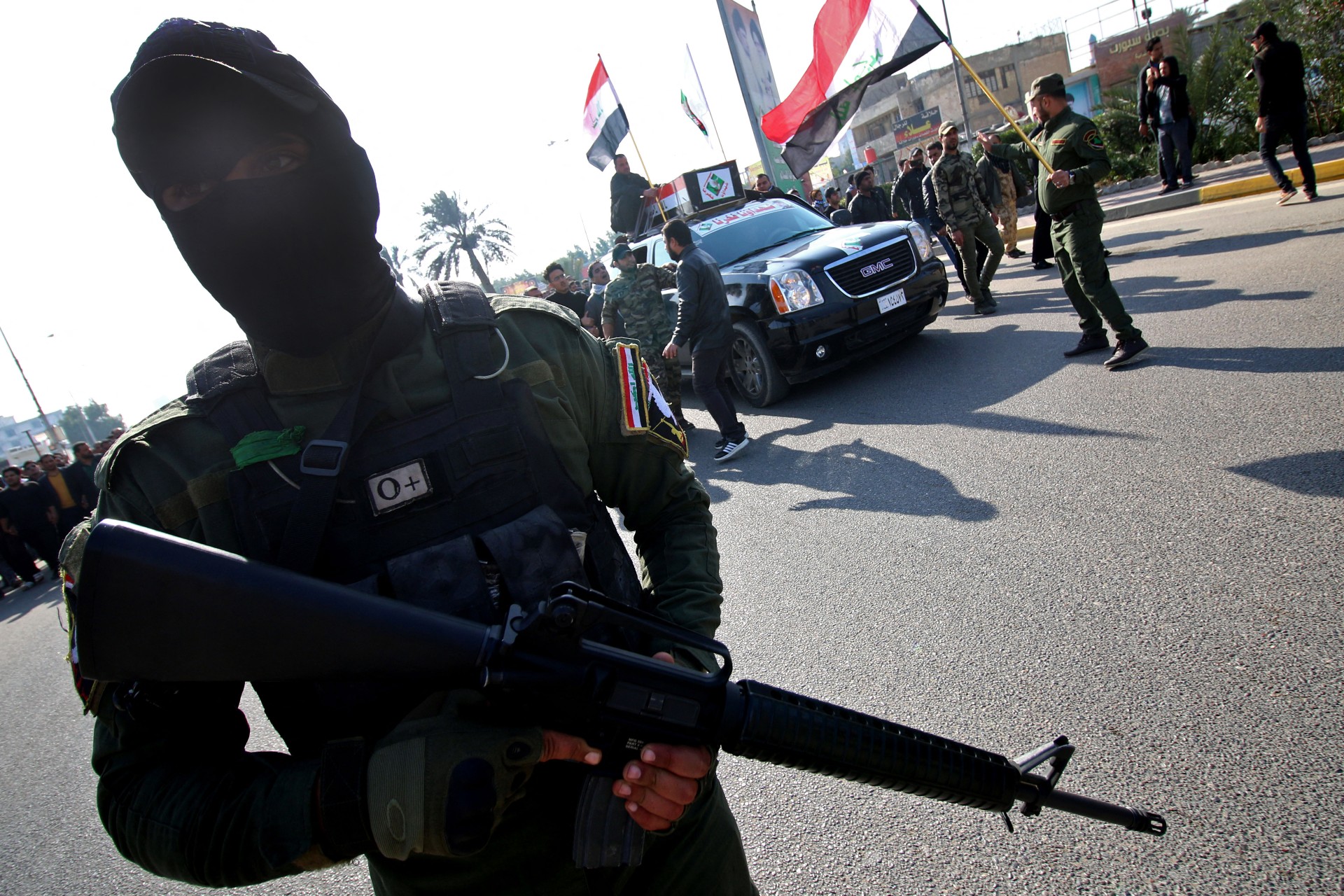 Sadrist fighters escort the coffin of a fighter who was killed in the northern city of Samarra at a funeral in Basra in 2017 (AFP)