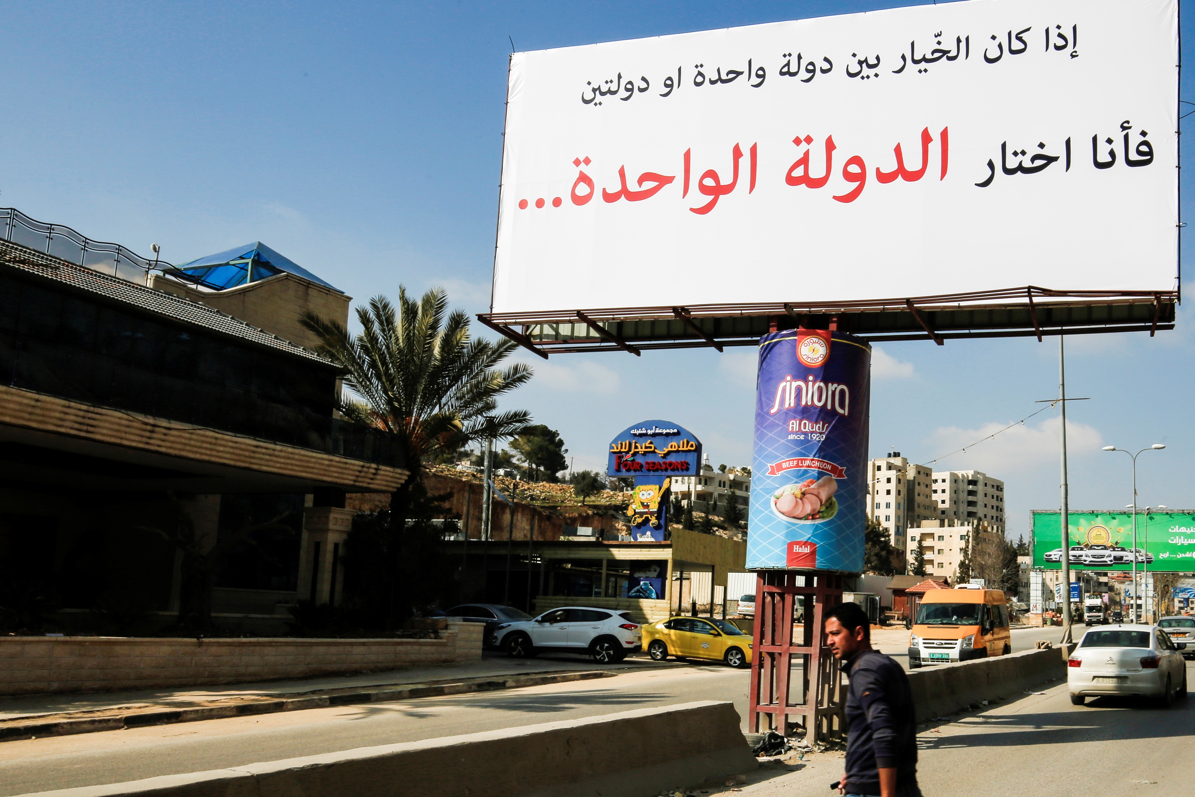 A picture taken on February 23, 2017 shows a billboard, of unknown origin, on a main road leading to the West Bank city of Ramallah, reading in Arabic: 