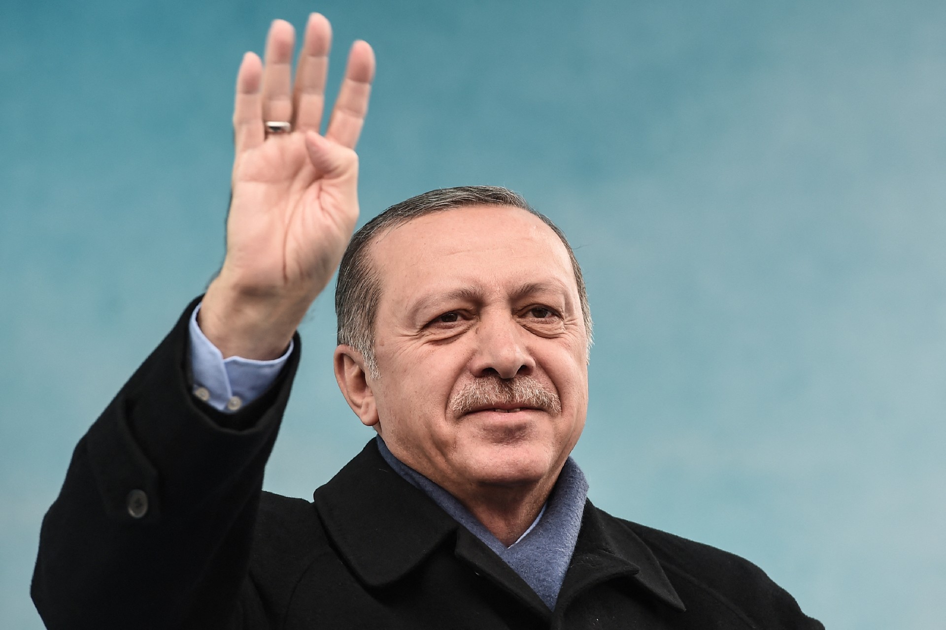 Erdogan greets supporters with the four-finger 