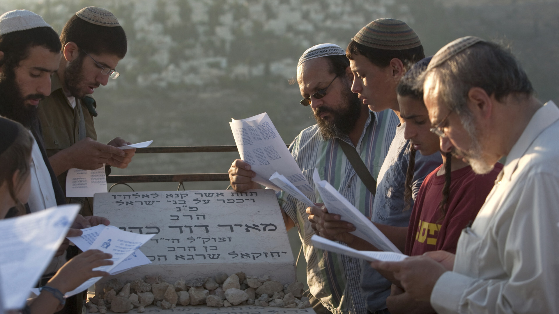 Followers of Meir Kahane pray at his grave at the Givat Shaul cemetery on the outskirts of Jerusalem on 26 October, 2010, to mark the 20th anniversary of his assassination (AFP)