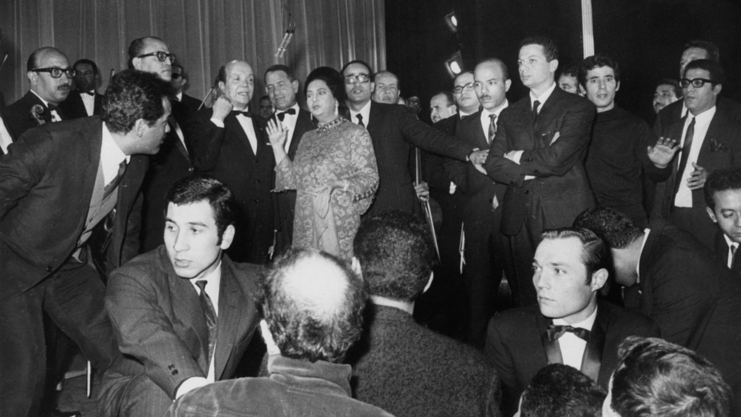 Egyptian singer Umm Kulthum is pictured with her musicians following a concert at the Olympia theatre in Paris, on 16 November 1967 (AFP)