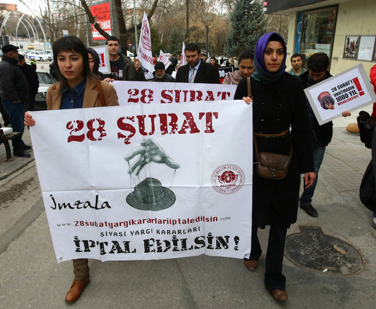 Demonstrators commemorating the 28 February 1997 ousting of the Welfare Party government in 2013 with posters reading: 