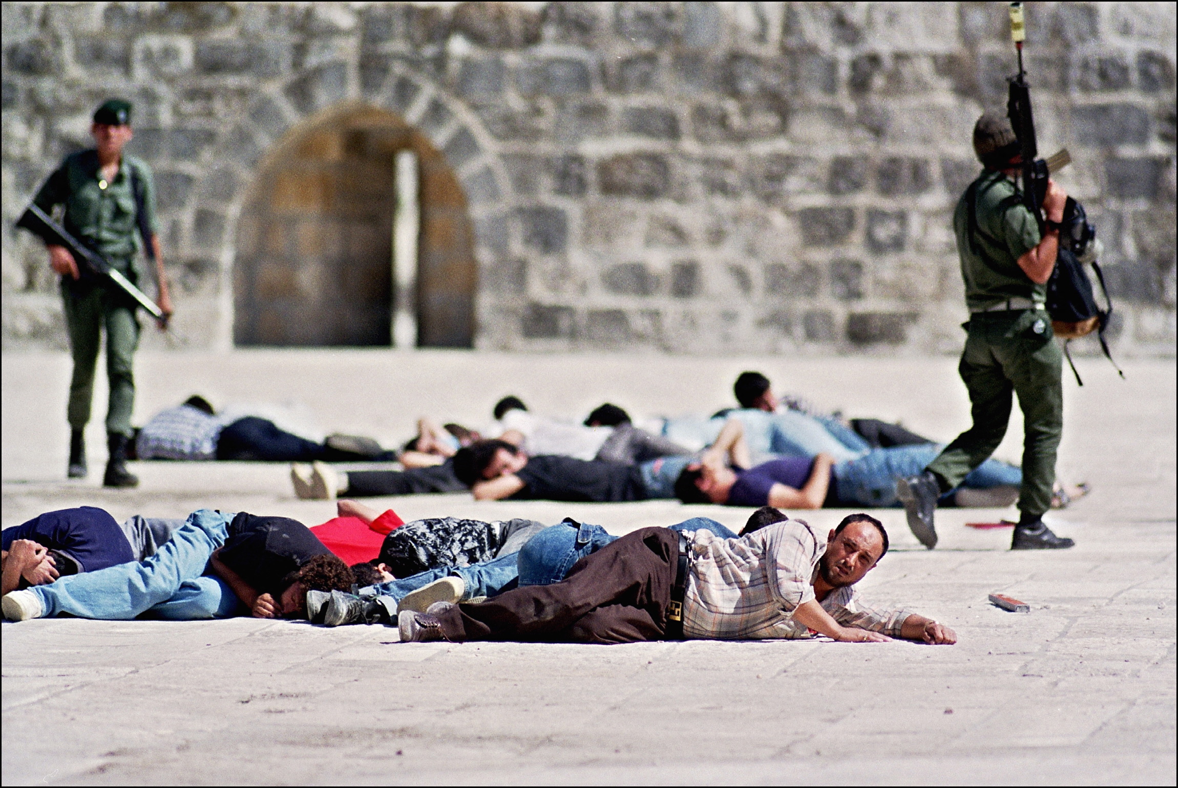 Israeli border policemen stand over arrested Palestinians 8 October 1990 following the protests at the Al-Aqsa mosque compound in Jerusalem's Old City (AFP)
