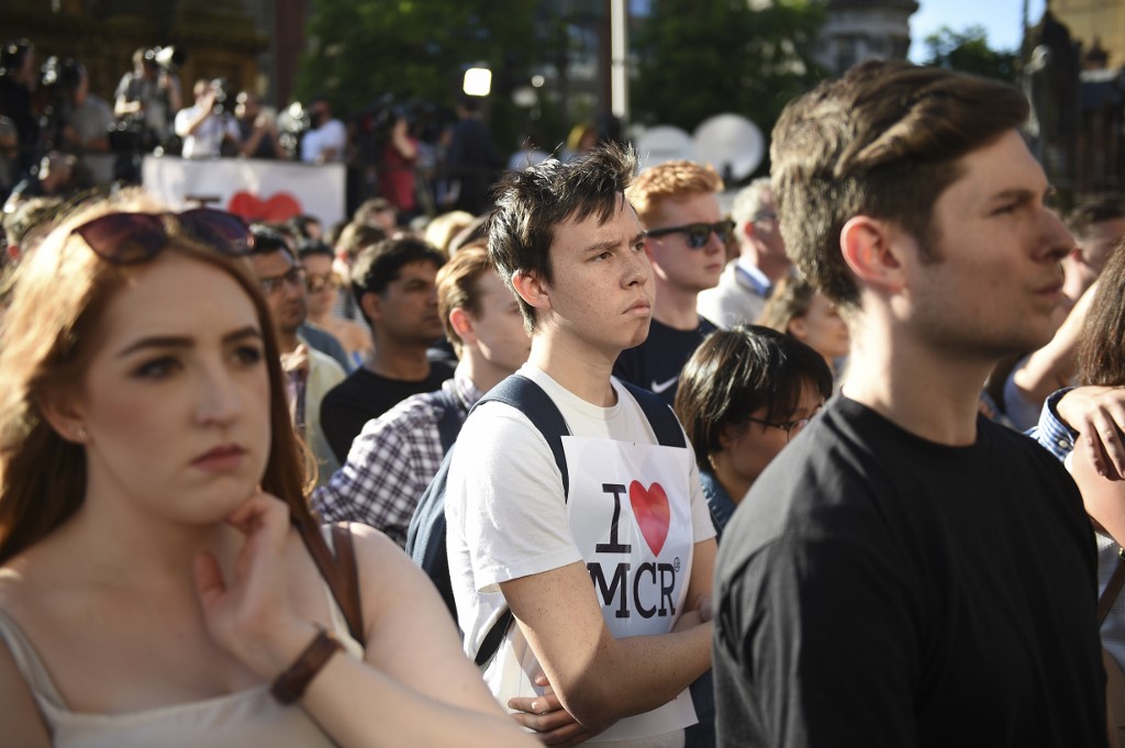 People attend a vigil in Manchester a day after the attack at the Ariana Grande concert in May 2017 (AFP)