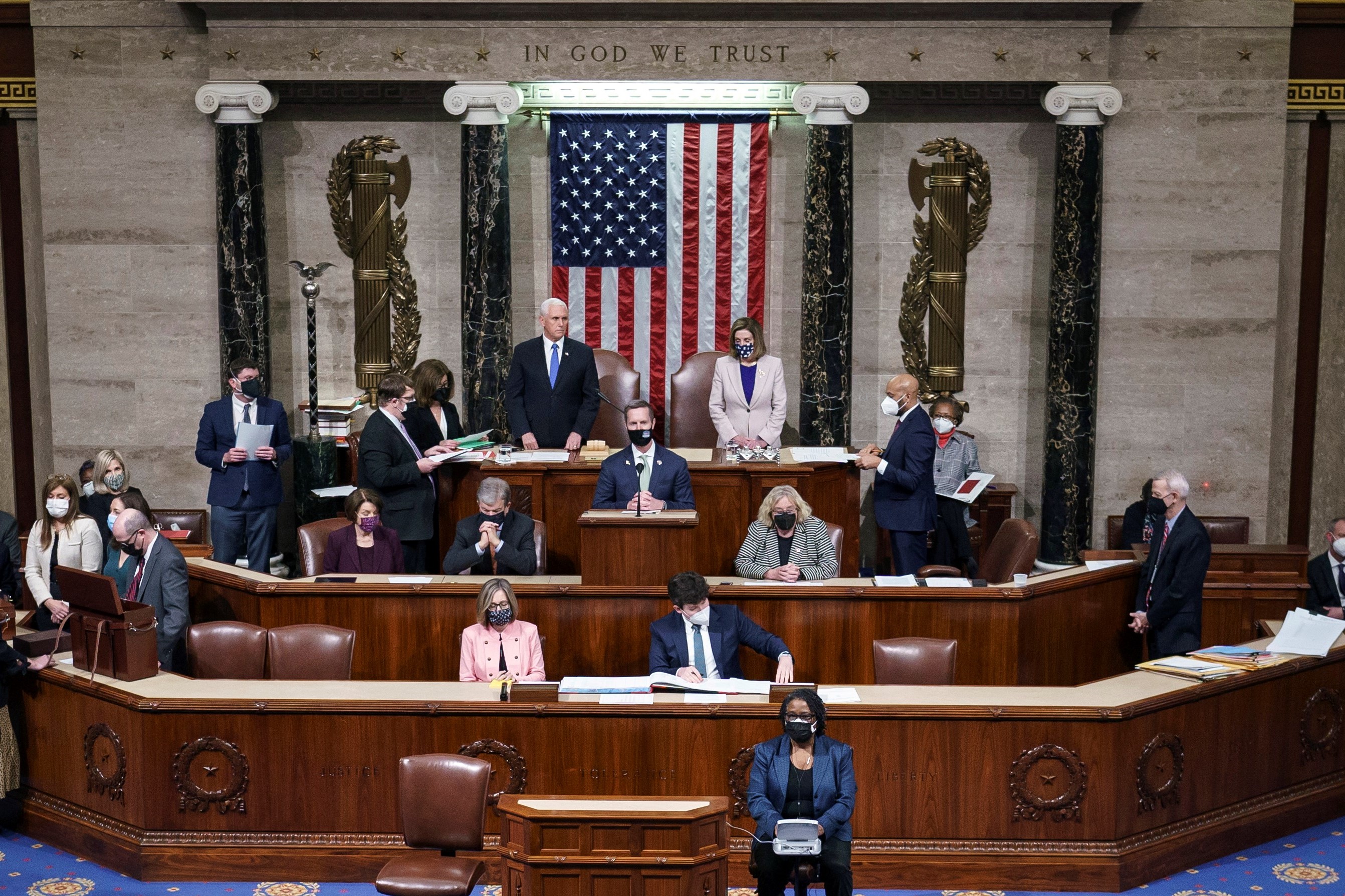 Vice President Mike Pence and Speaker of the House Nancy Pelosi, D-Calif., stand after to reading the final certification of Electoral College votes cast in November's presidential election during a joint session of Congress, after working through the night, at the Capitol on January 7, 2021 in Washington, DC.