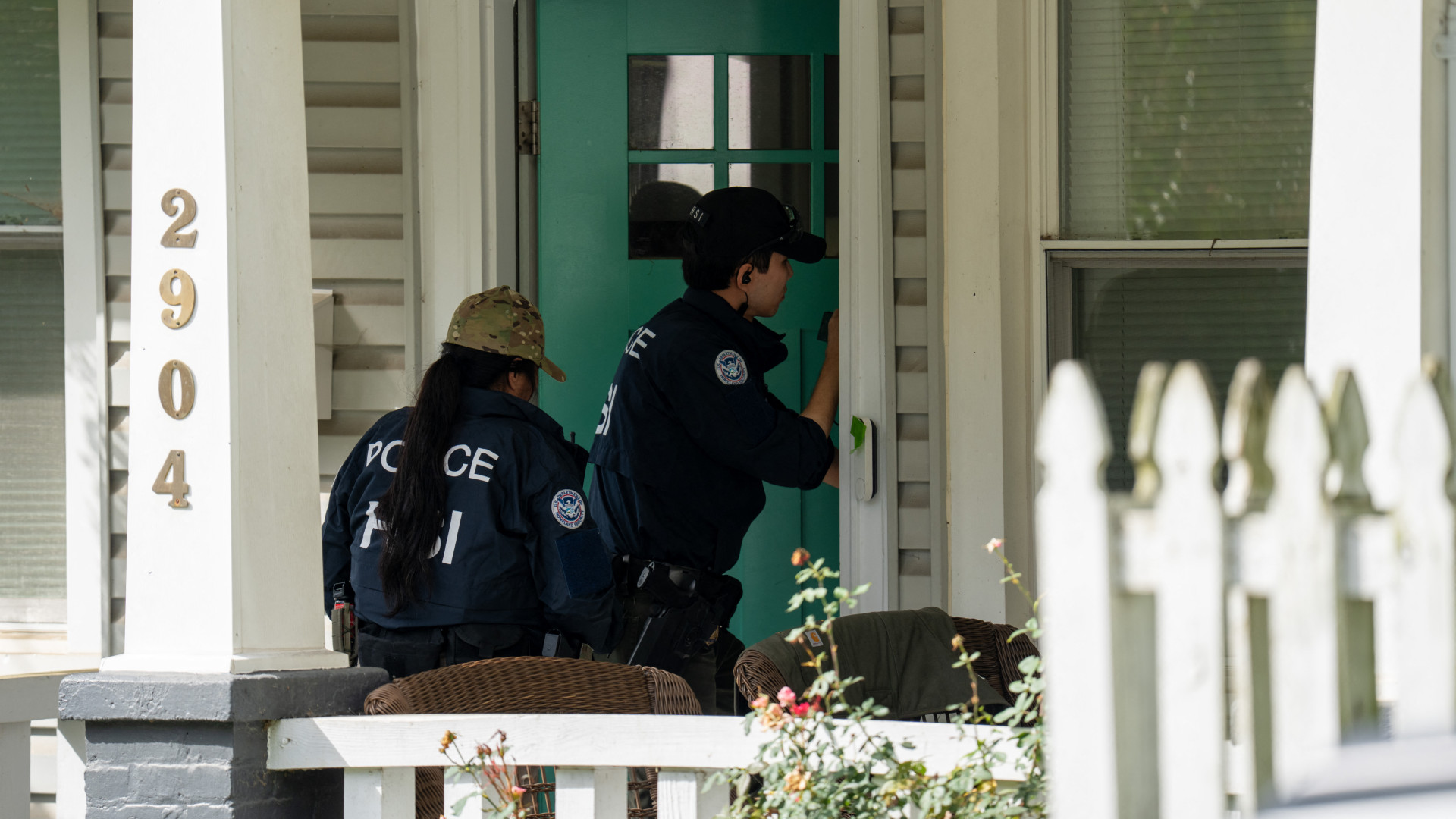 Homeland Security Investigations agents at the door of Congresswoman Ilhan Omar's home in Washington, DC, on 12 October 2026 (Andrew Leyden/Getty Images via AFP)