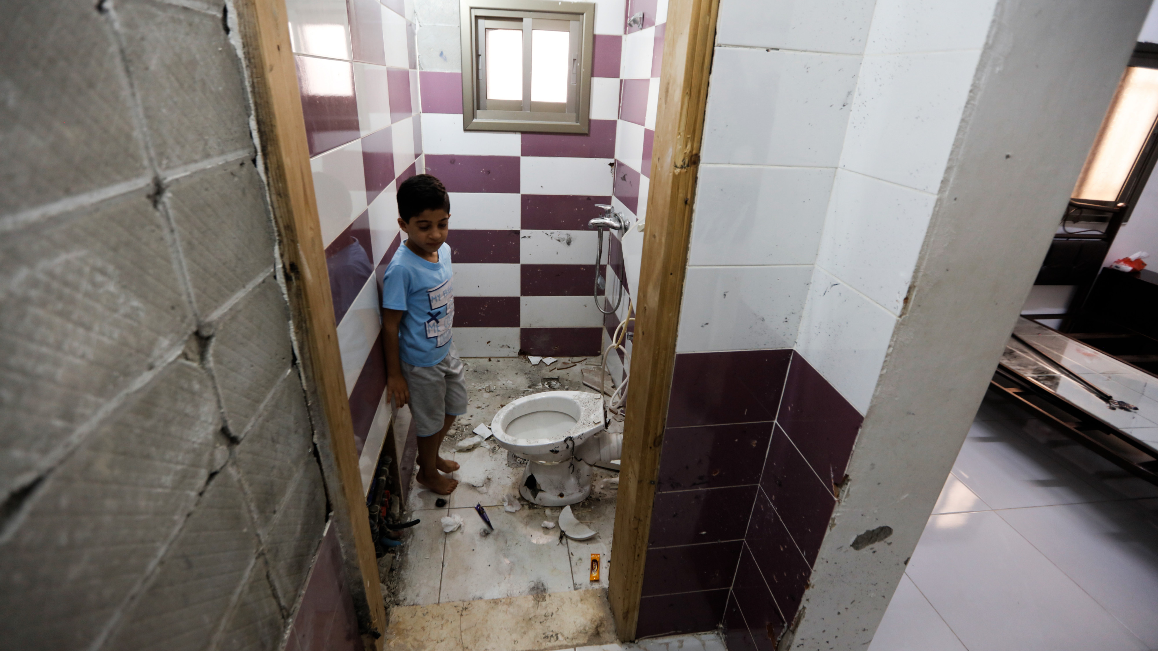 Karam Muqbil, Fidah's seven-year-old brother, standing admits the destruction caused by Israeli forces storming into their home near Jericho on 1 May 2023 (MEE/Palestine Productions)