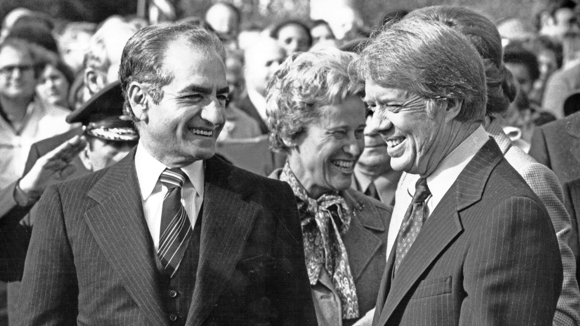 US President Jimmy Carter, right, and Mohammad Reza Pahlavi, the Shah of Iran, left, smile at one another as the shah arrived for a state visit at the White House in Washington, DC, on 15 November 1977 (Benjamin E. “Gene” Forte/ CNP/Sipa USA)