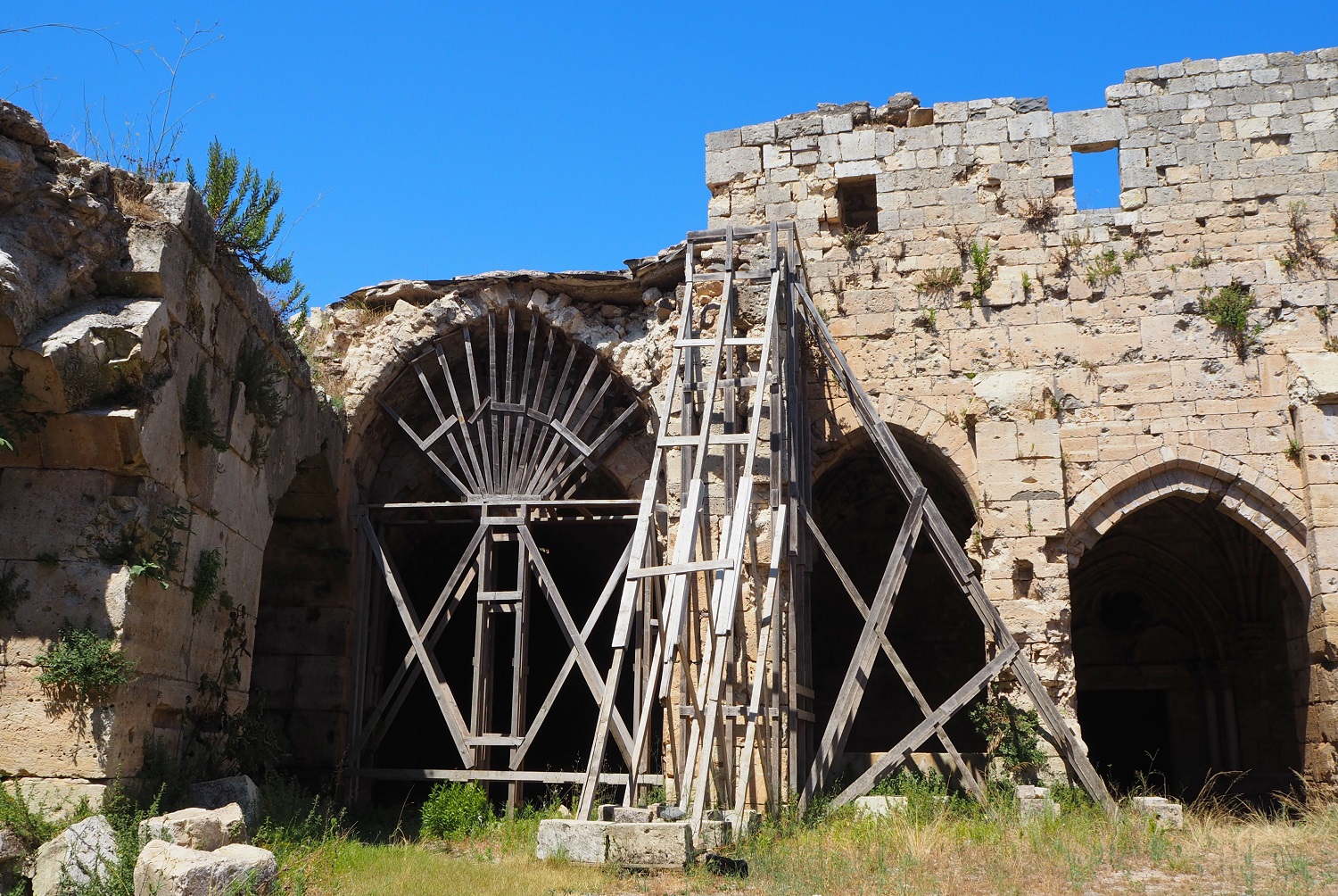 Some damaged areas are shored up wth wooden scaffolding, pending funds to repair the stonework (Tom Westcott/MEE)