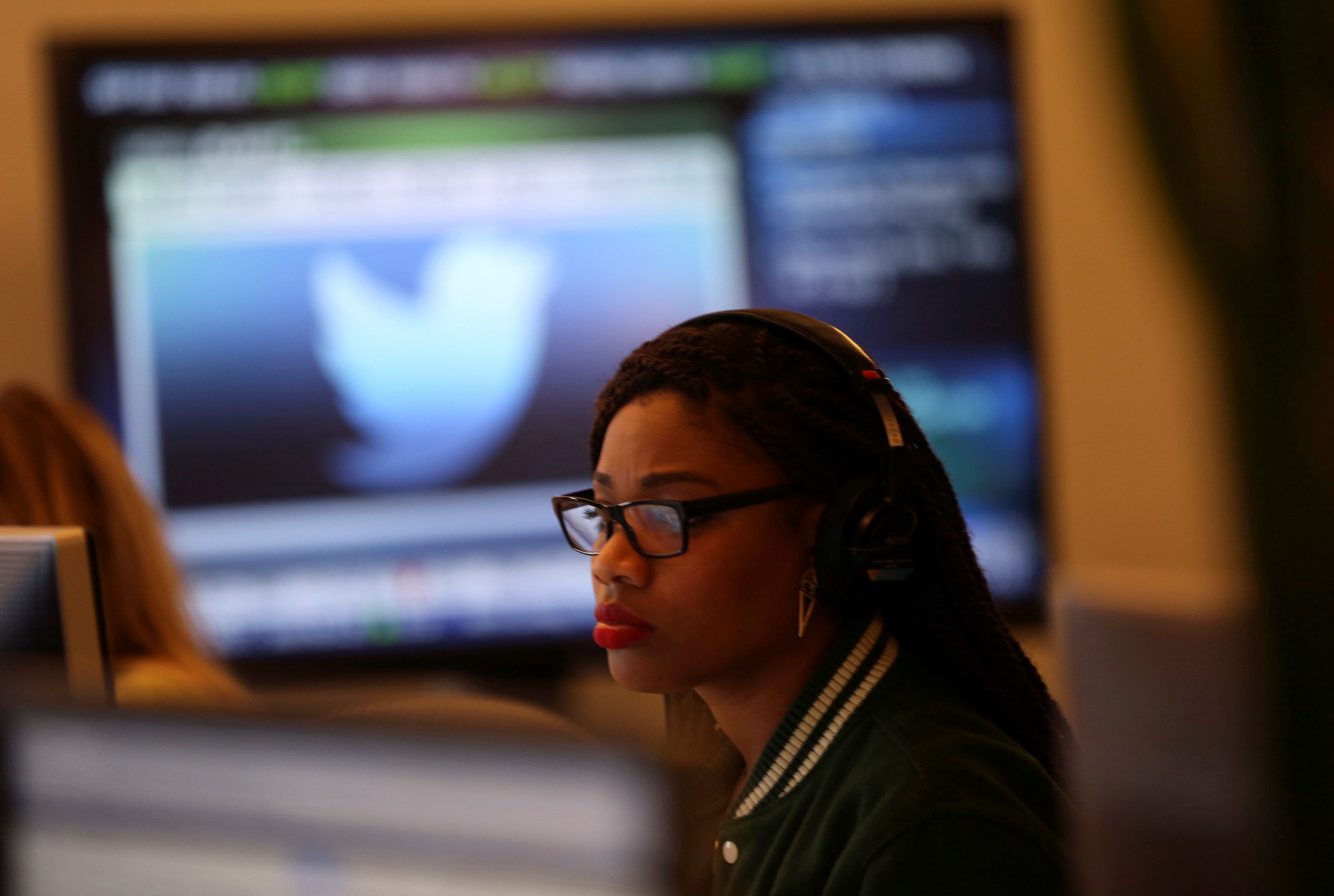 A Twitter employee works at a computer at the company's headquarters in San Francisco (Reuters)