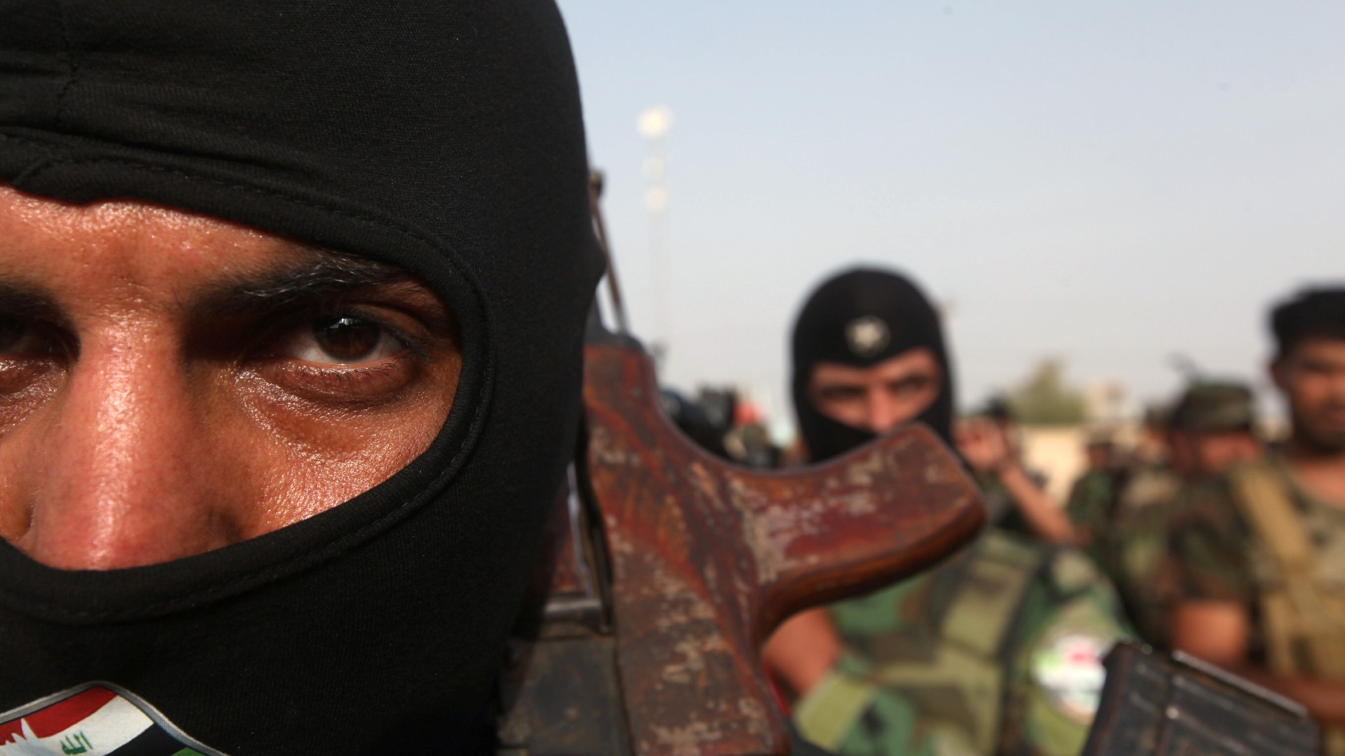 Saraya al-Salam fighters take part in a parade along a street in Najaf in 2016 (Reuters)